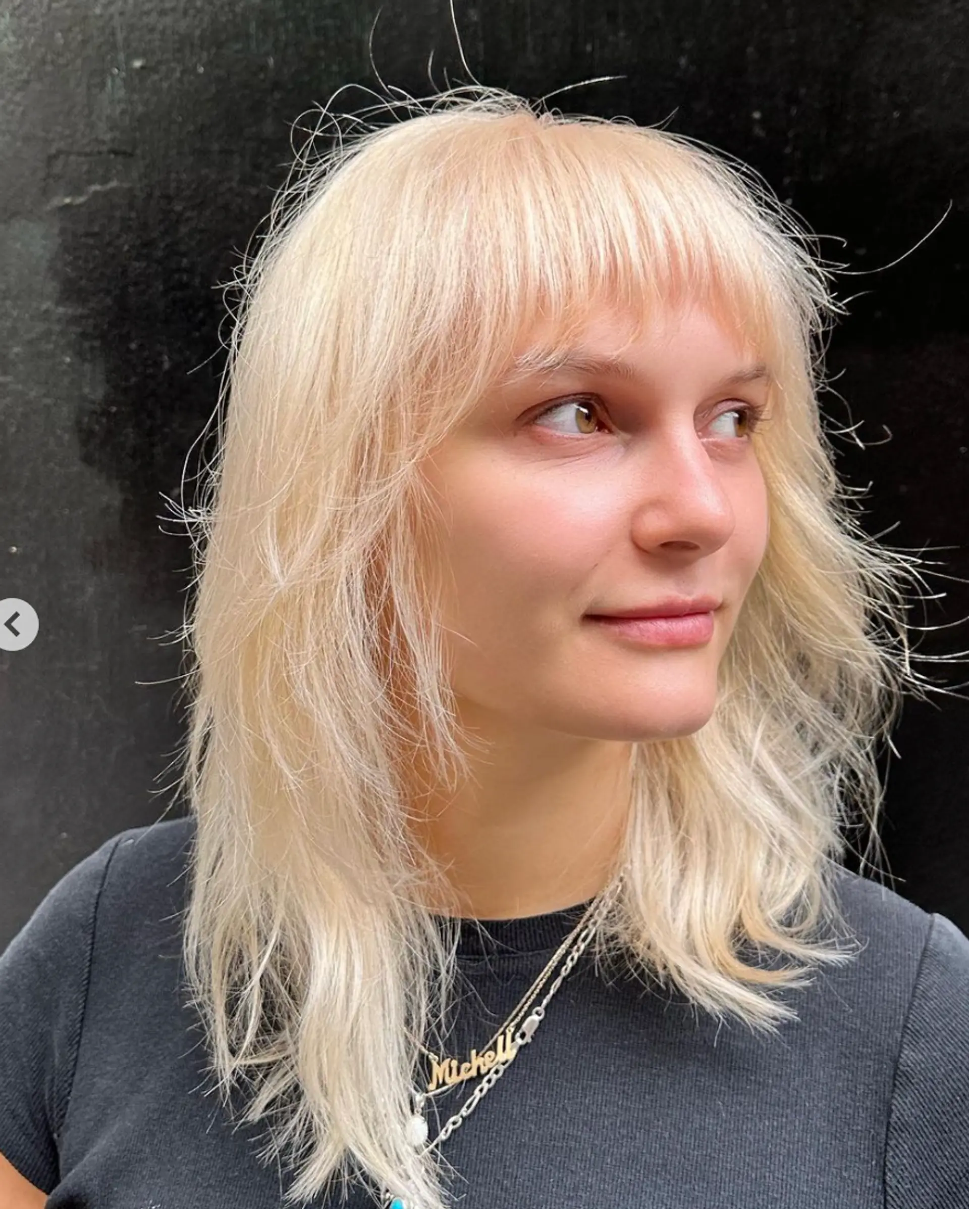 Medium-length, straight platinum blonde hair with a natural shine, casual waves, and feathered tips.

Color by @simabeautynyc
Cut and style by @juliamannino_hair
 2