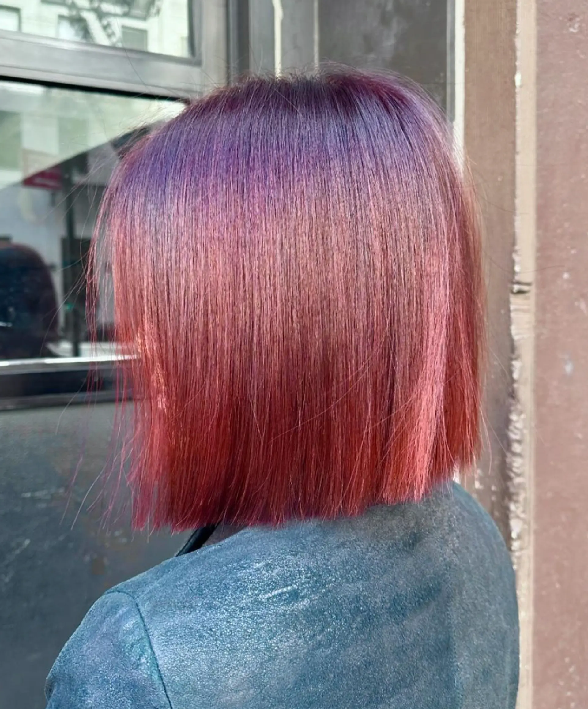 A sleek, blunt-cut medium bob with a straight texture, featuring vibrant plum, red, and purple hues for a modern and eye-catching look. 2