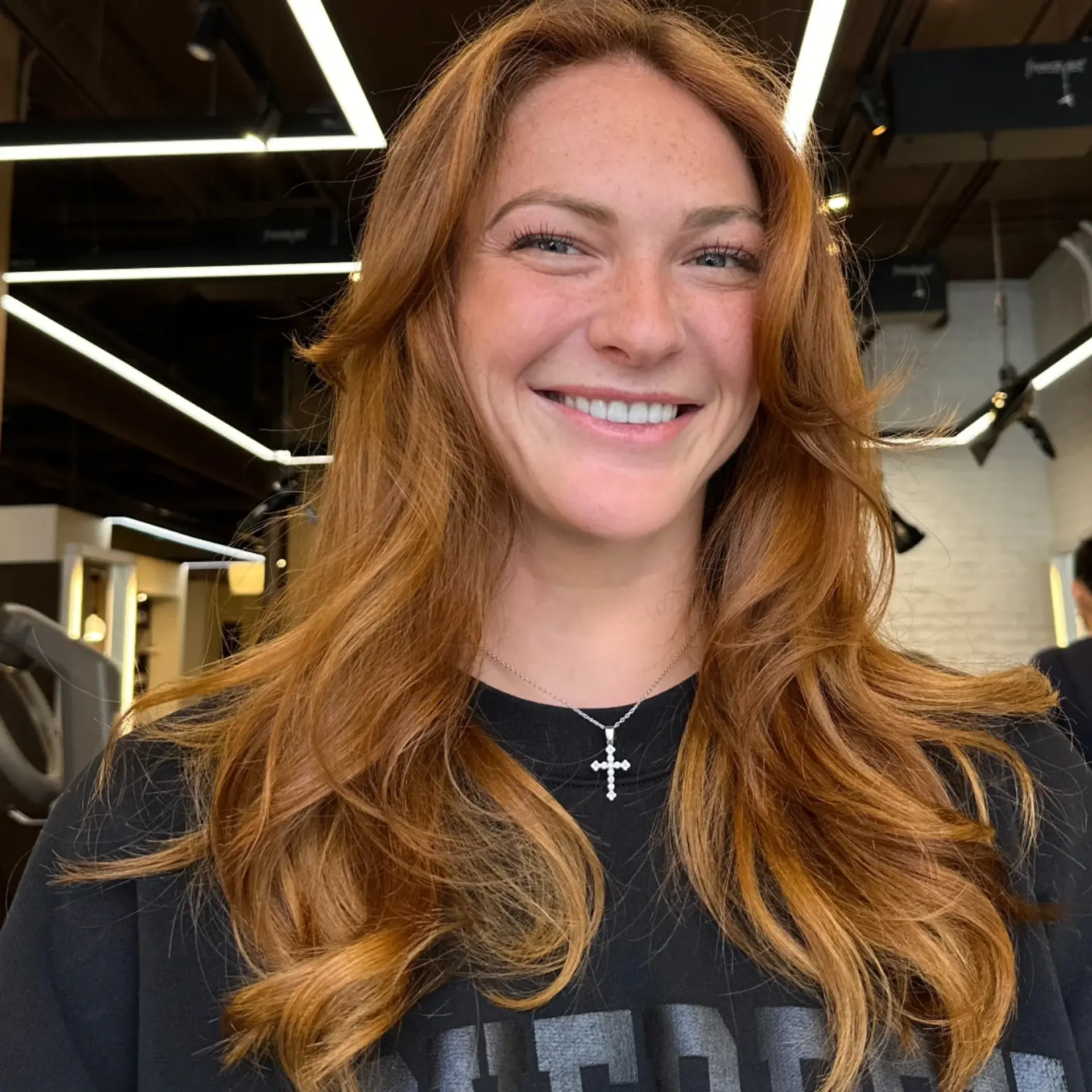 A medium-length wavy hairstyle with face-framing layers. 1