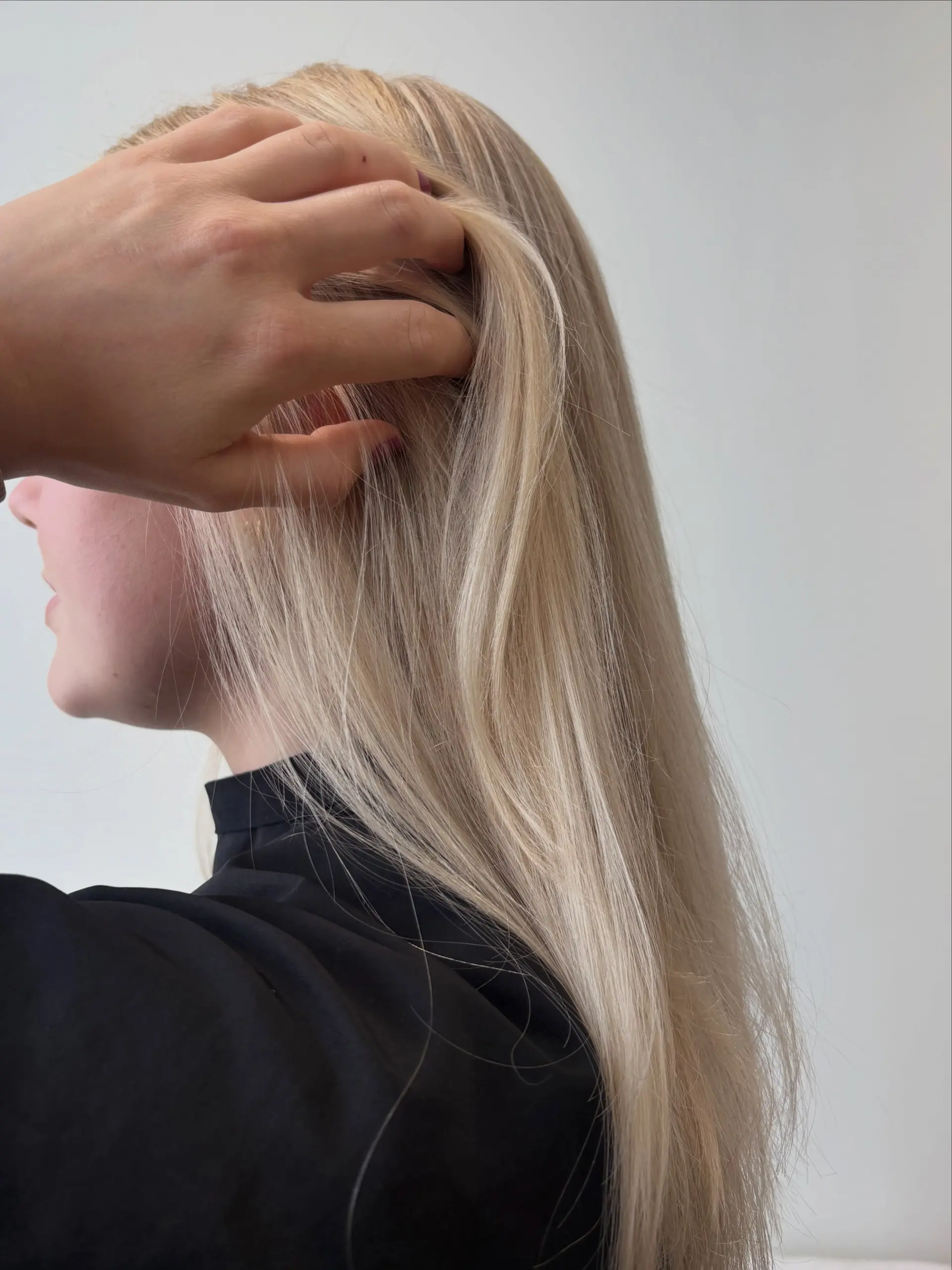 Long, sleek platinum blonde hair styled straight and smooth. 1