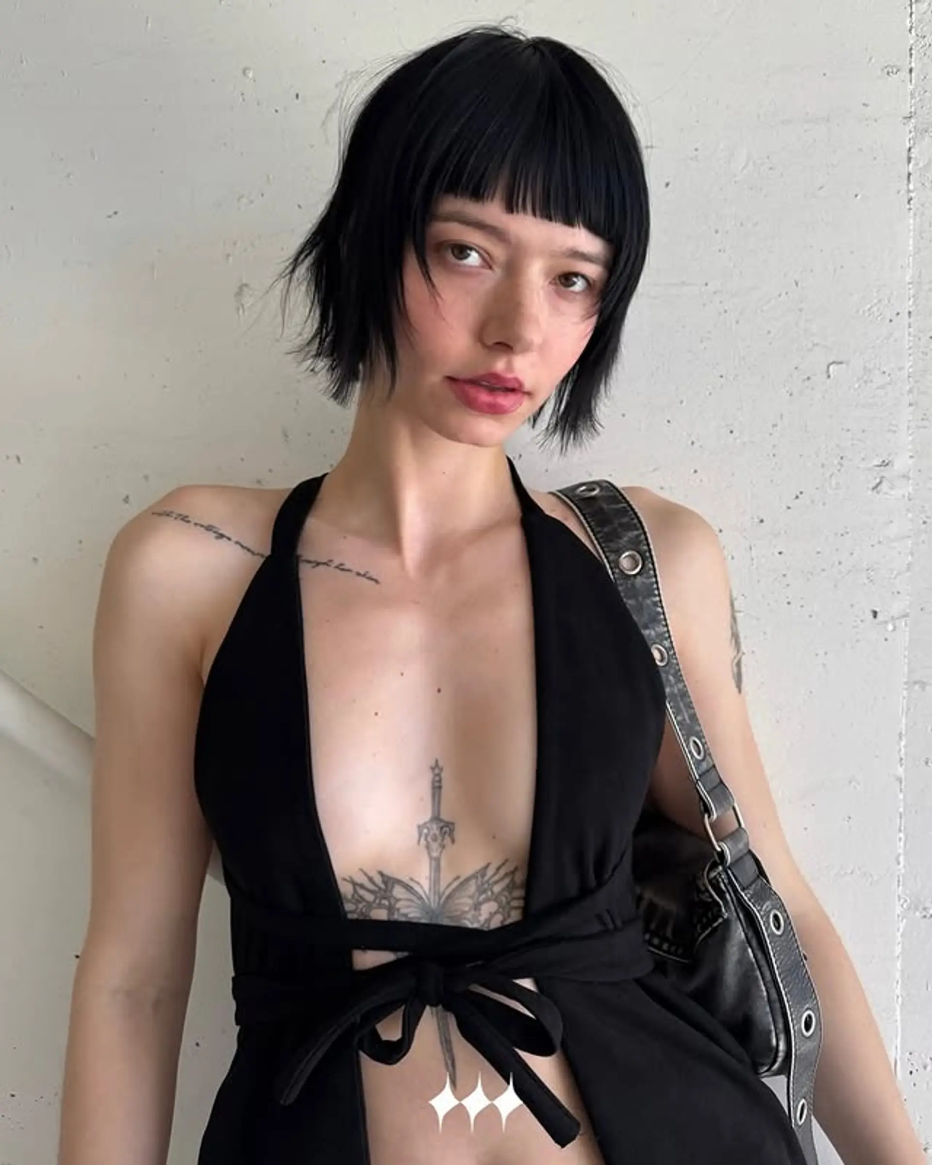 A short, choppy blunt bob with straight bangs. 1