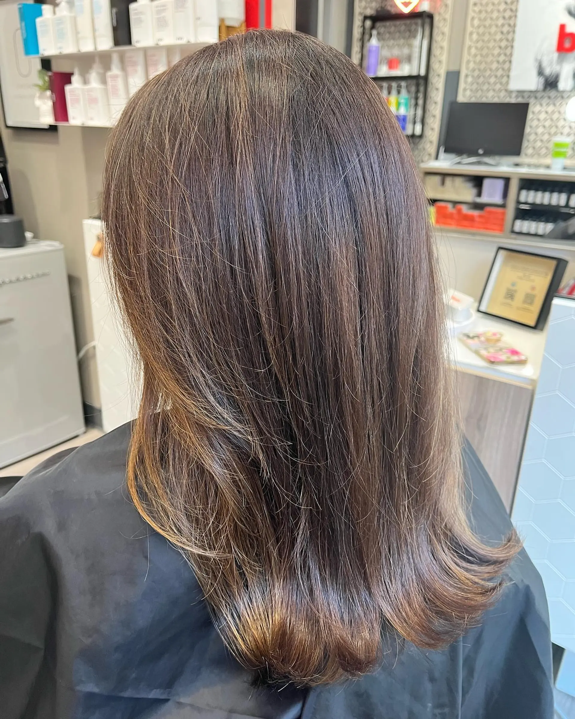A medium-length layered lob with subtle bronzed brunette highlights. 1