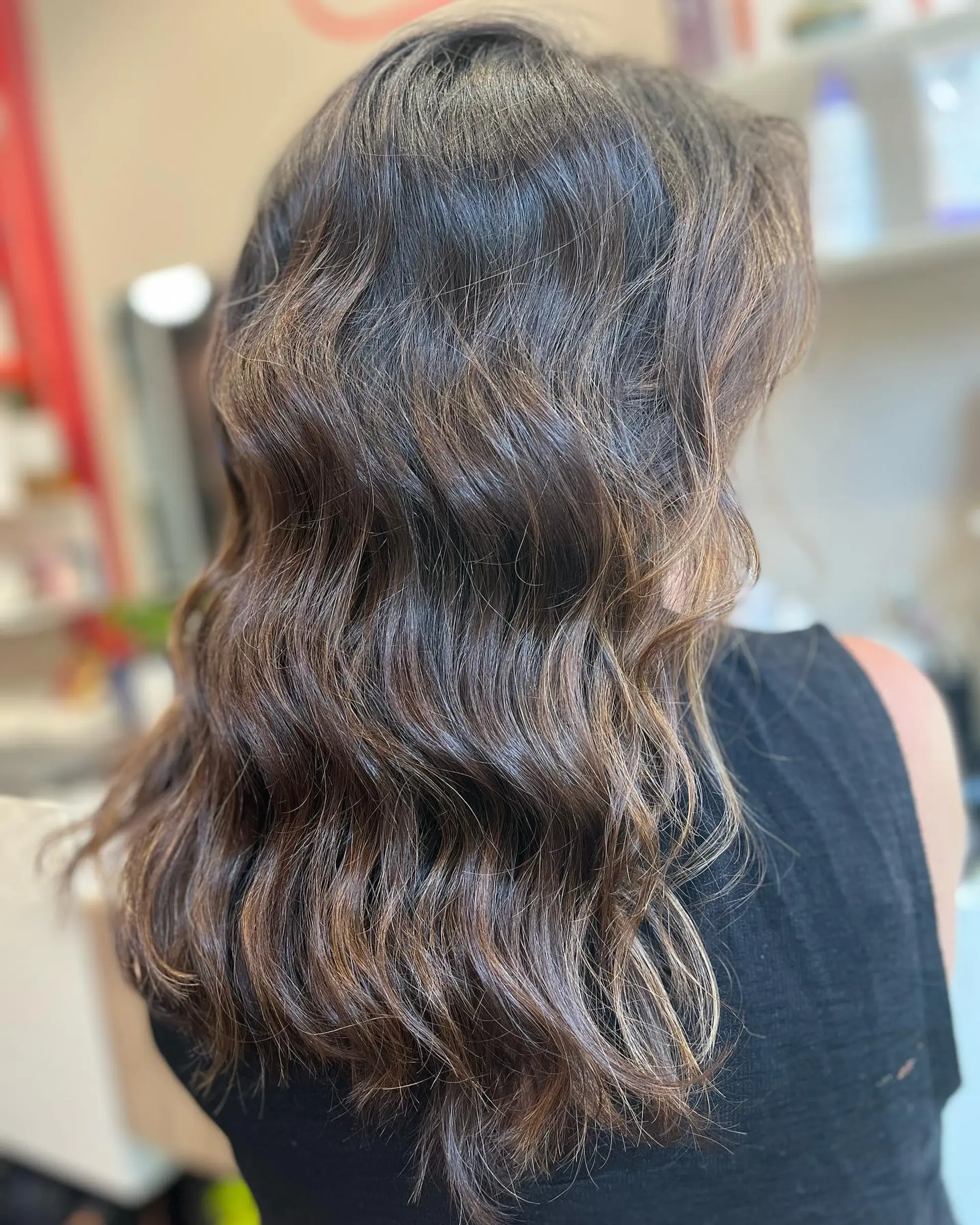A medium-length layered lob with subtle bronzed brunette highlights. 2