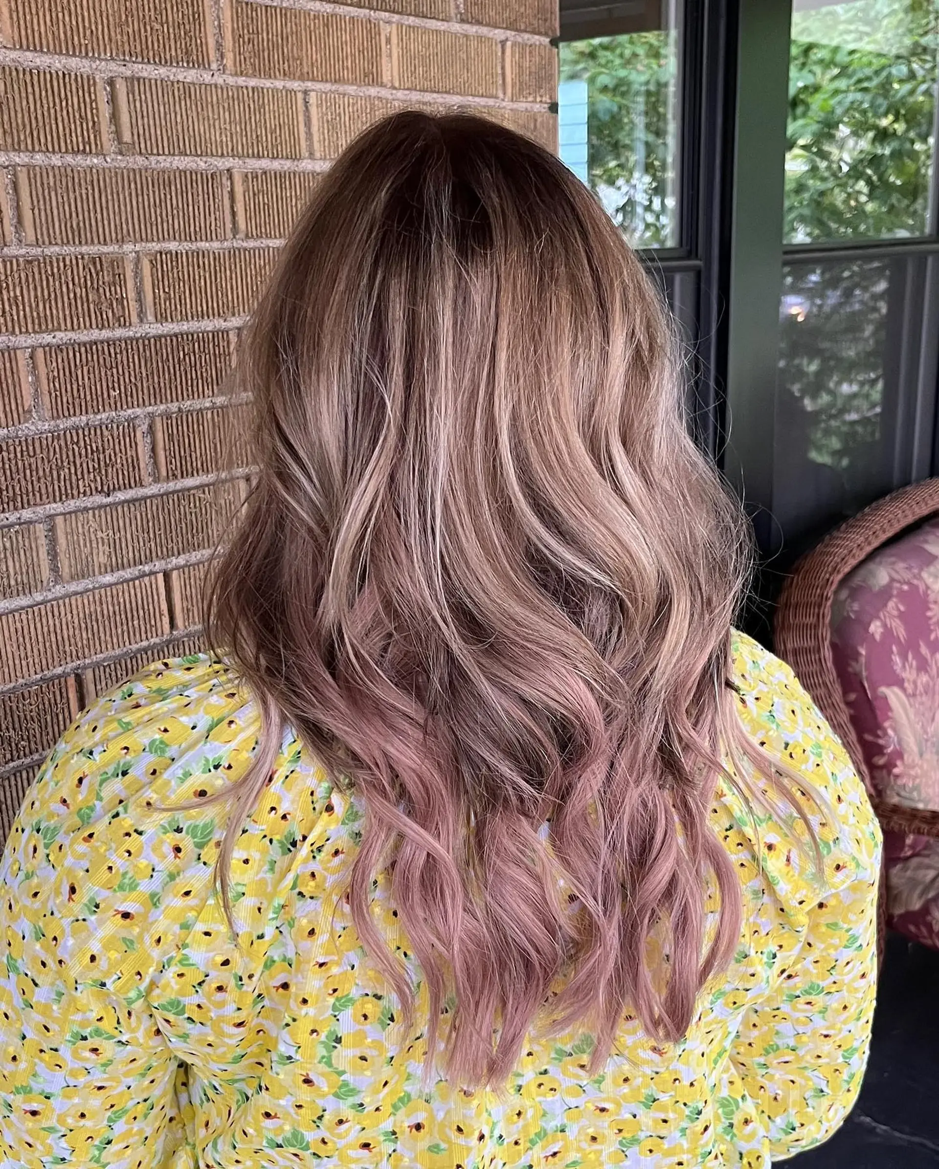 A medium-length wavy hairstyle with a rose gold ombre effect. 1