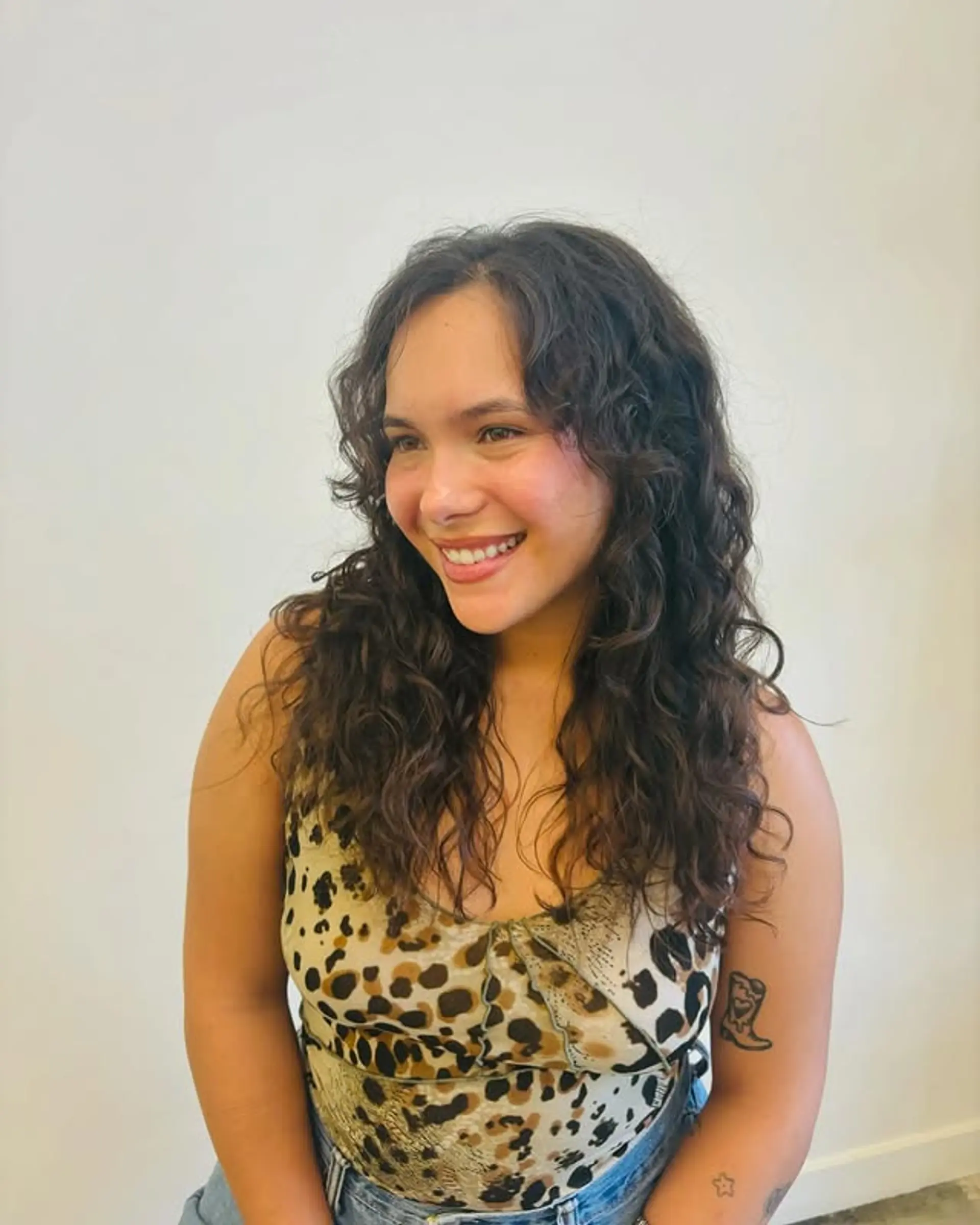 A textured shag haircut with curly bangs. 1