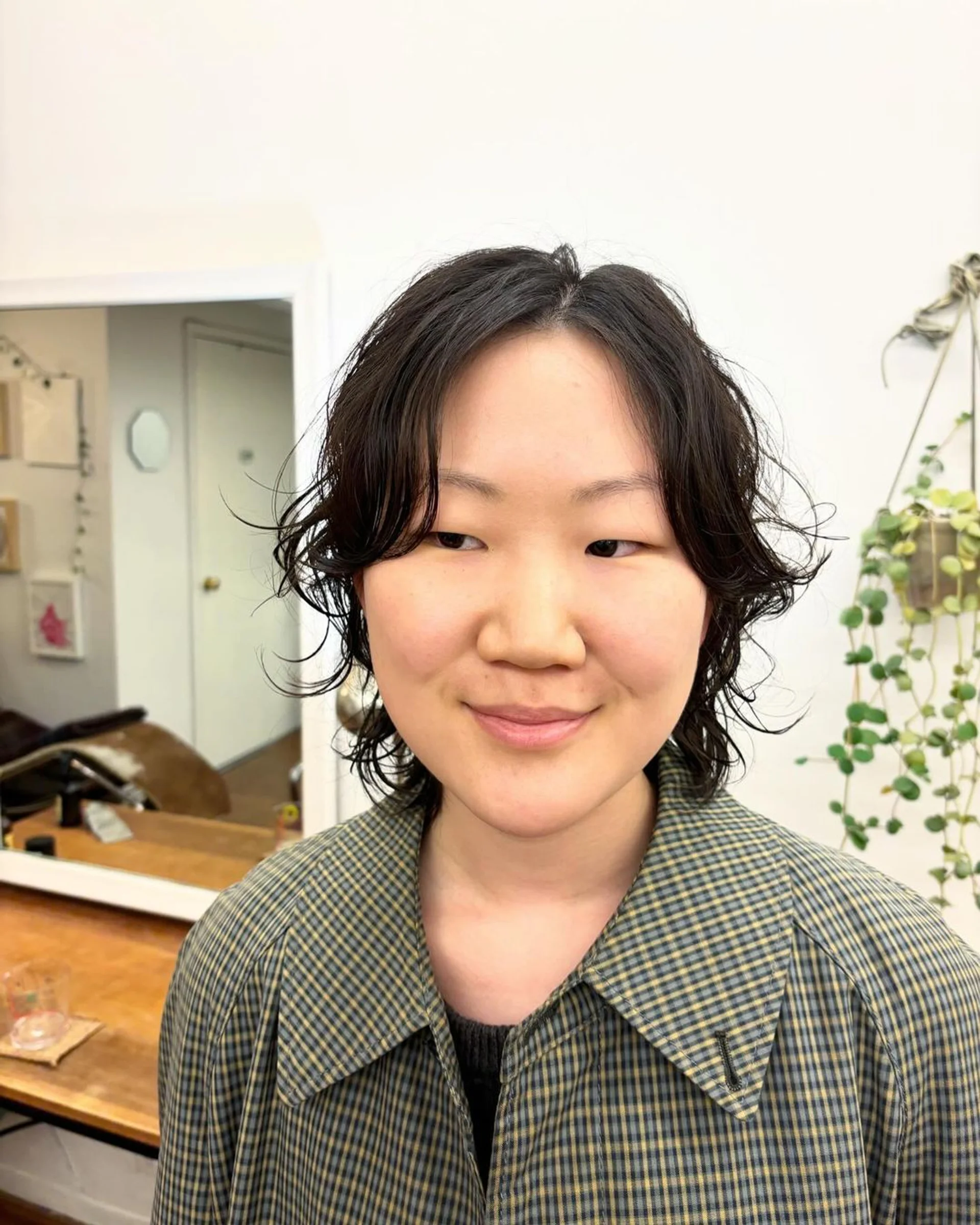A person with a chin-length dark brown bob with soft waves and blunt bangs, created with a digital perm. - Preview 2