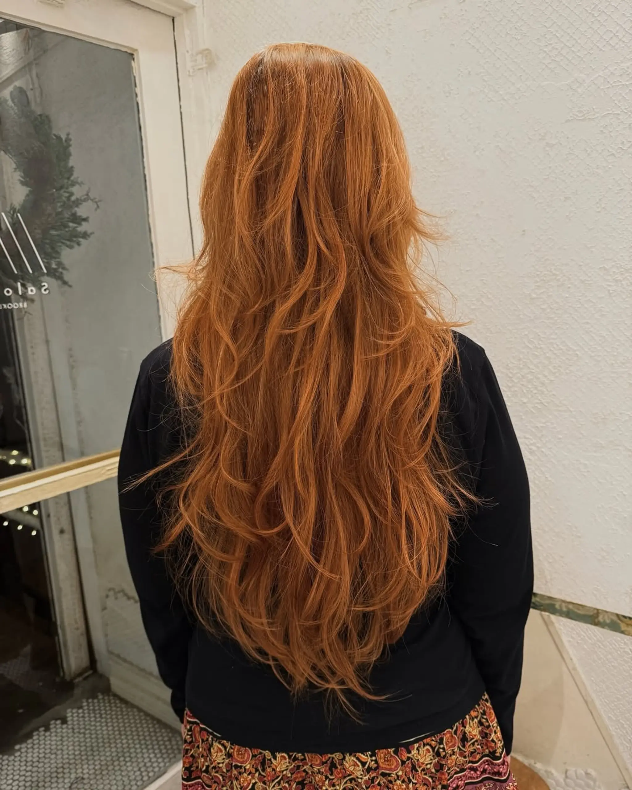 Voluminous very long wavy hair in a vibrant copper-red color with natural waves cascading down the back. 1