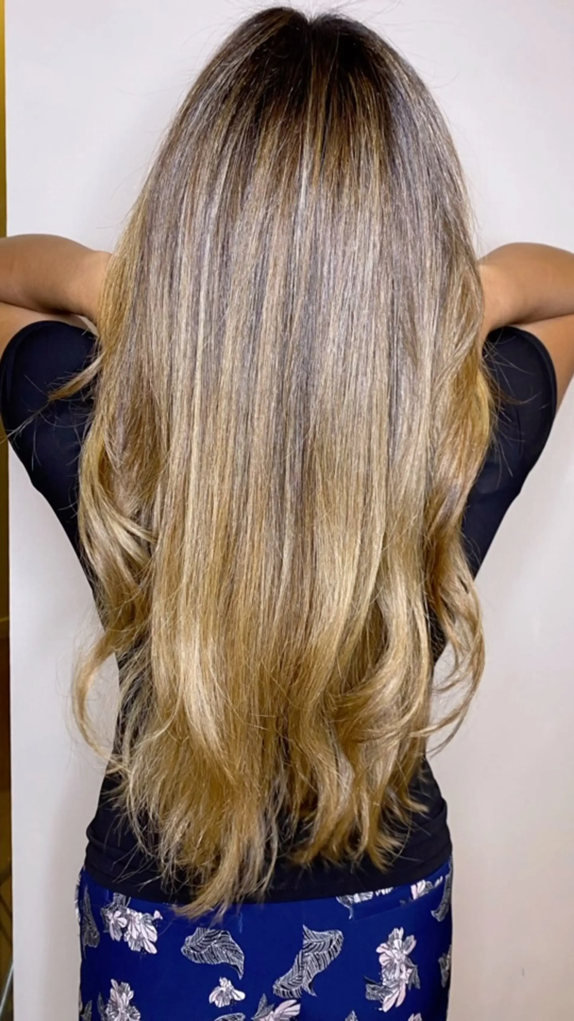 Long cool-toned ash blonde highlighted hair with softly waved ends. 1