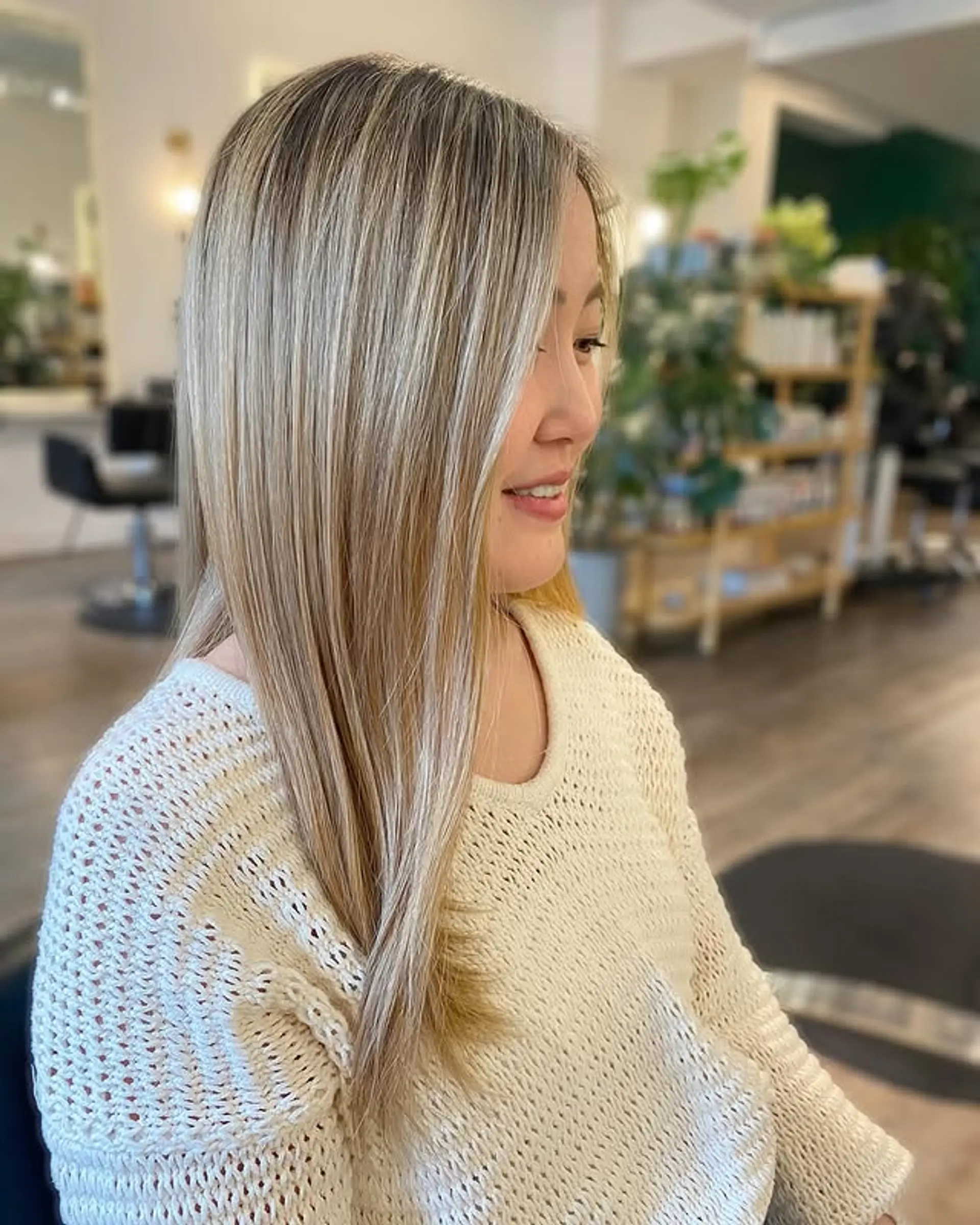 A medium-length straight lob featuring sun-kissed blonde highlights. 1