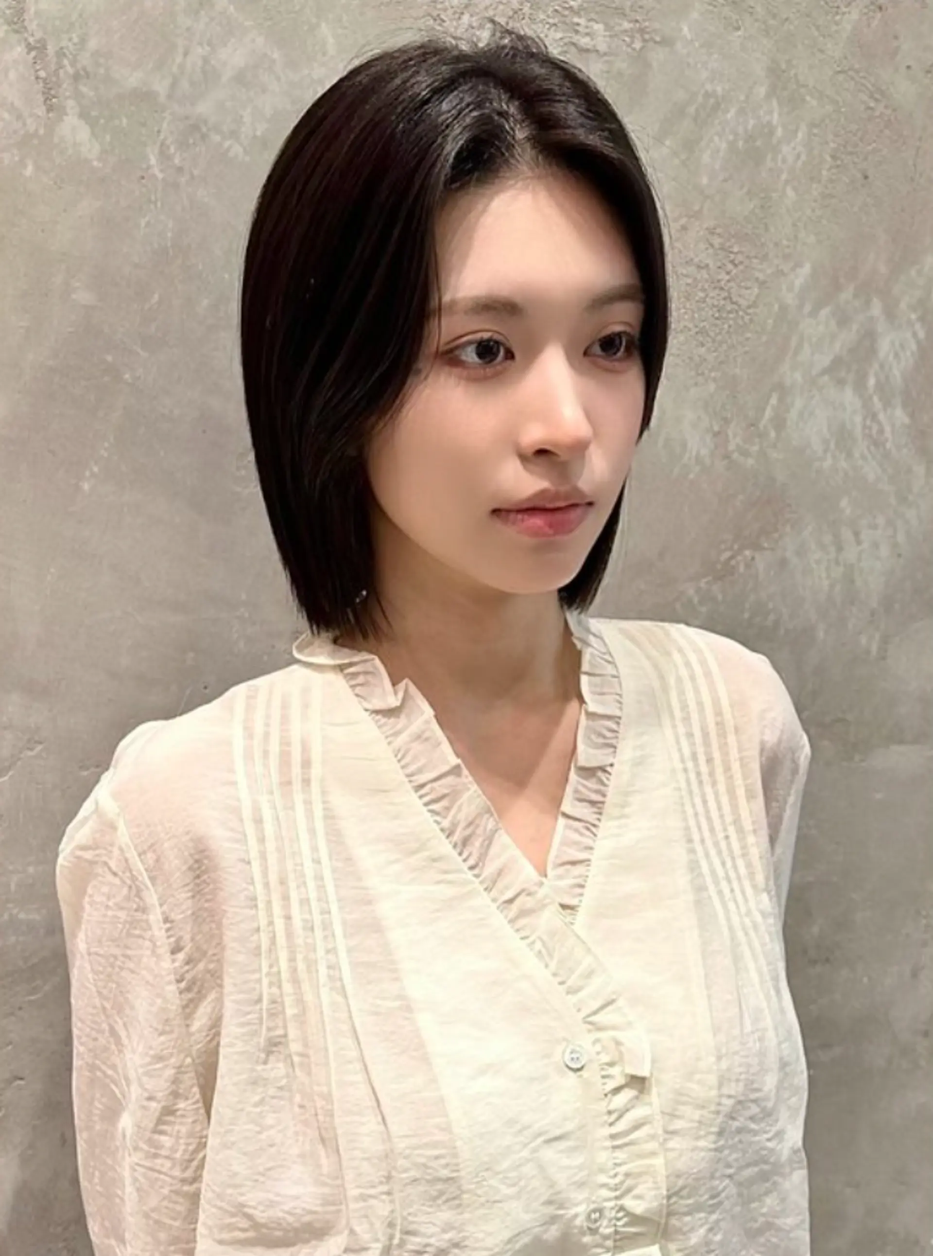 The 'Elegant Bob' hairstyle features medium-length, straight black hair falling to the shoulders with a polished, sleek texture. The clean cut and slight inward curve at the ends add sophistication and elegance. 1