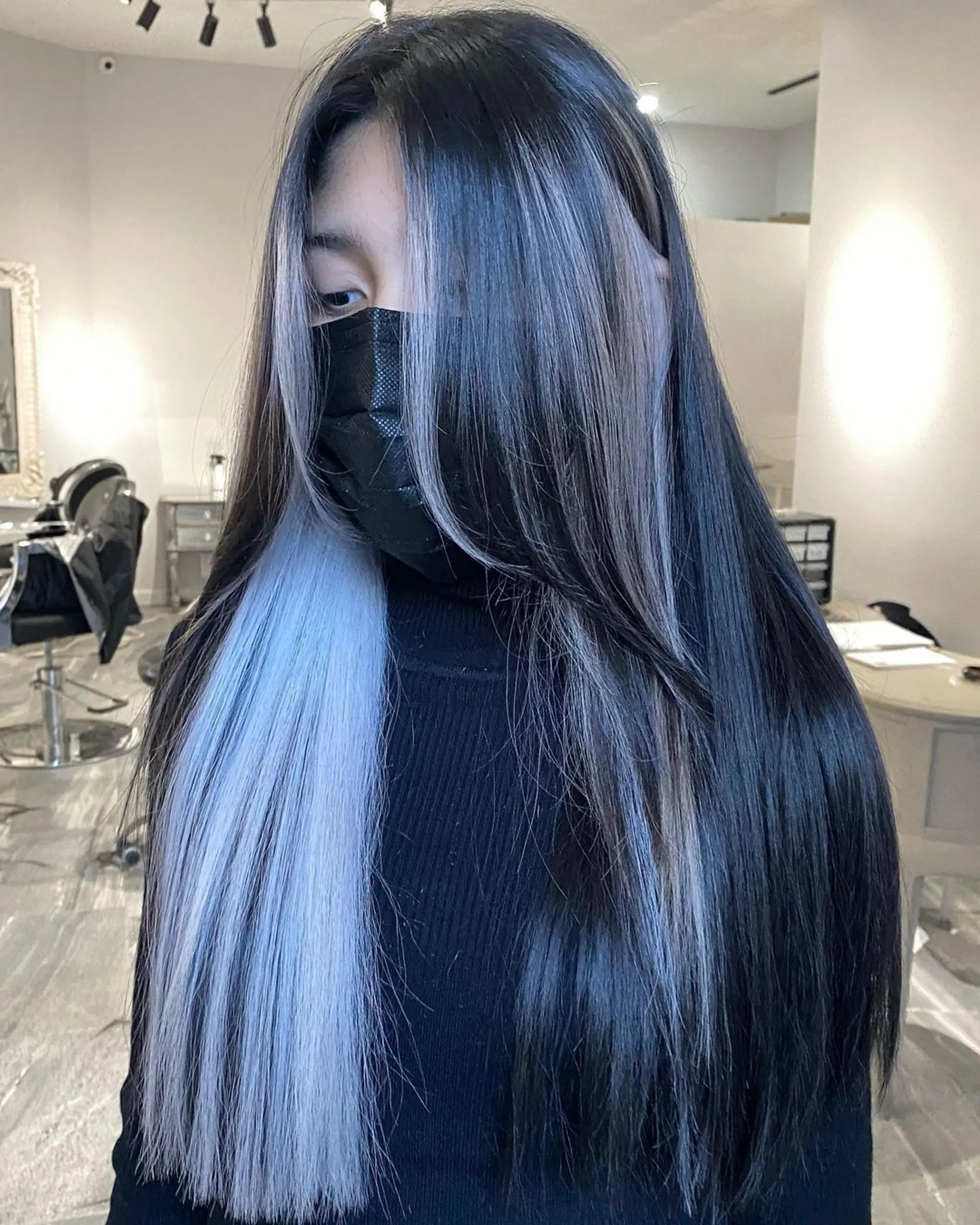 Long, straight hair in a two-toned style with black and platinum blonde colors, creating a striking and dramatic contrast.