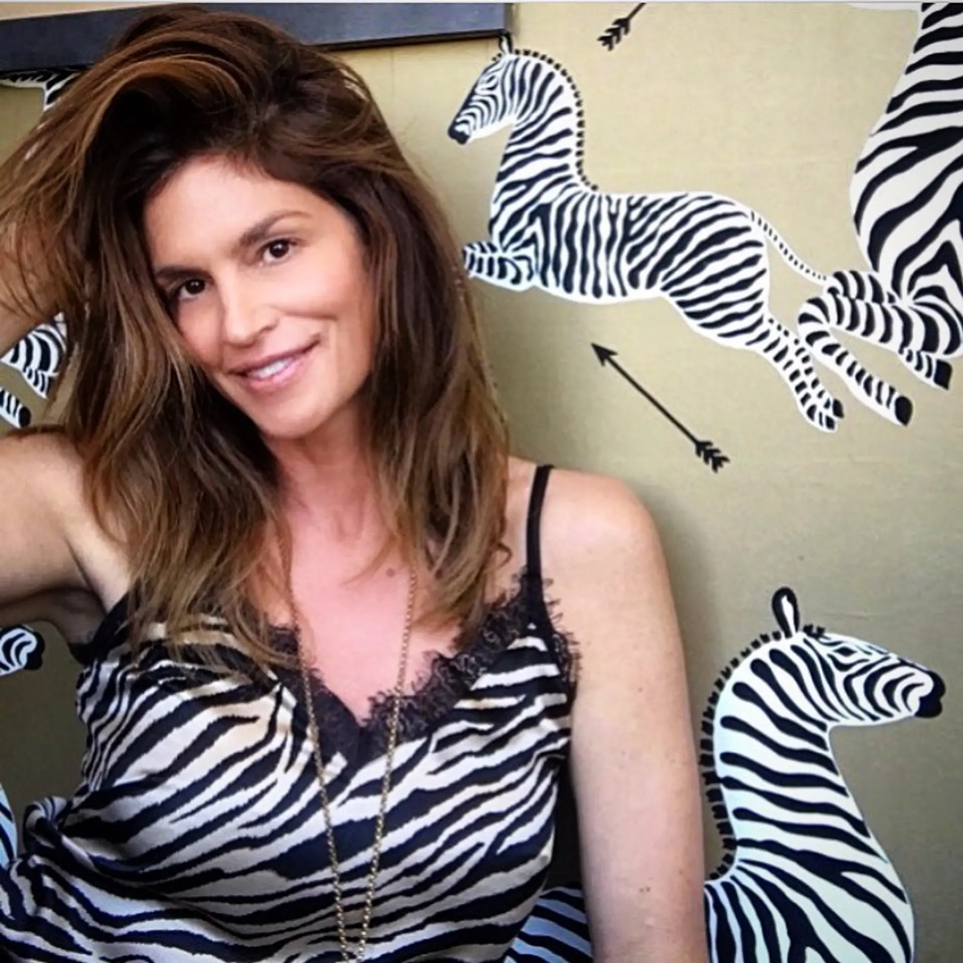 A voluminous, tousled brunette blowout with soft body and face-framing dimension. 1