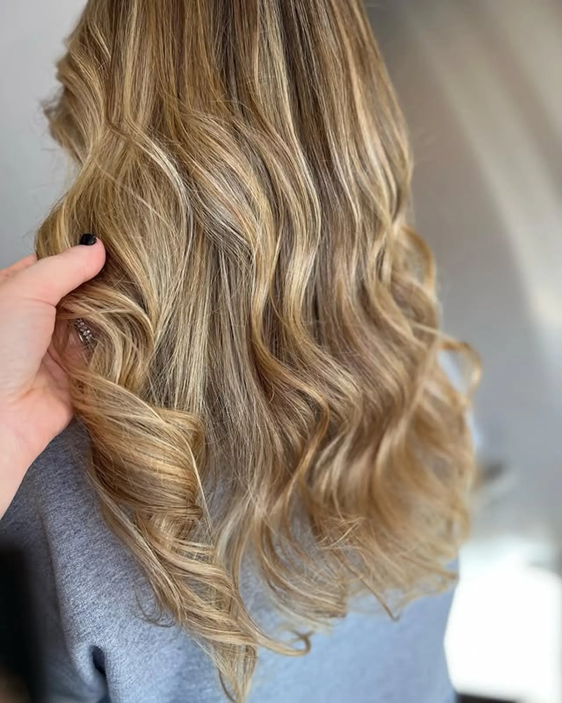 Long, wavy hairstyle with golden blonde balayage highlights. 1