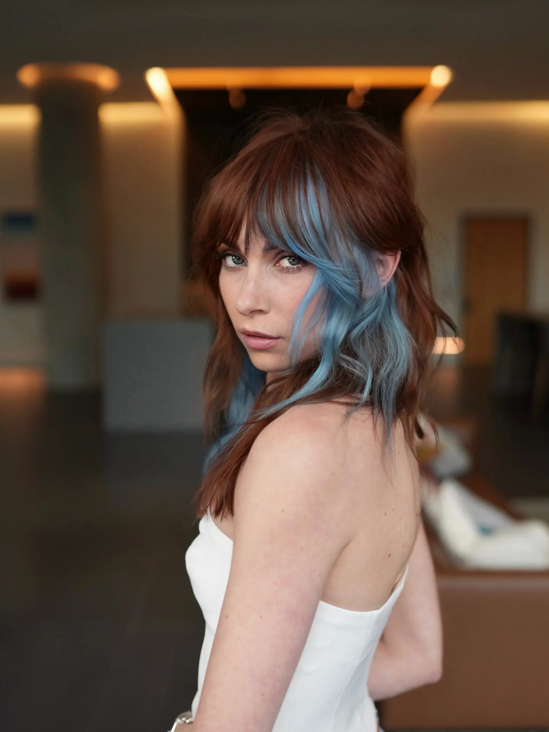 Medium-length textured copper shag featuring a pastel denim-blue color-blocked fringe and face frame. 1