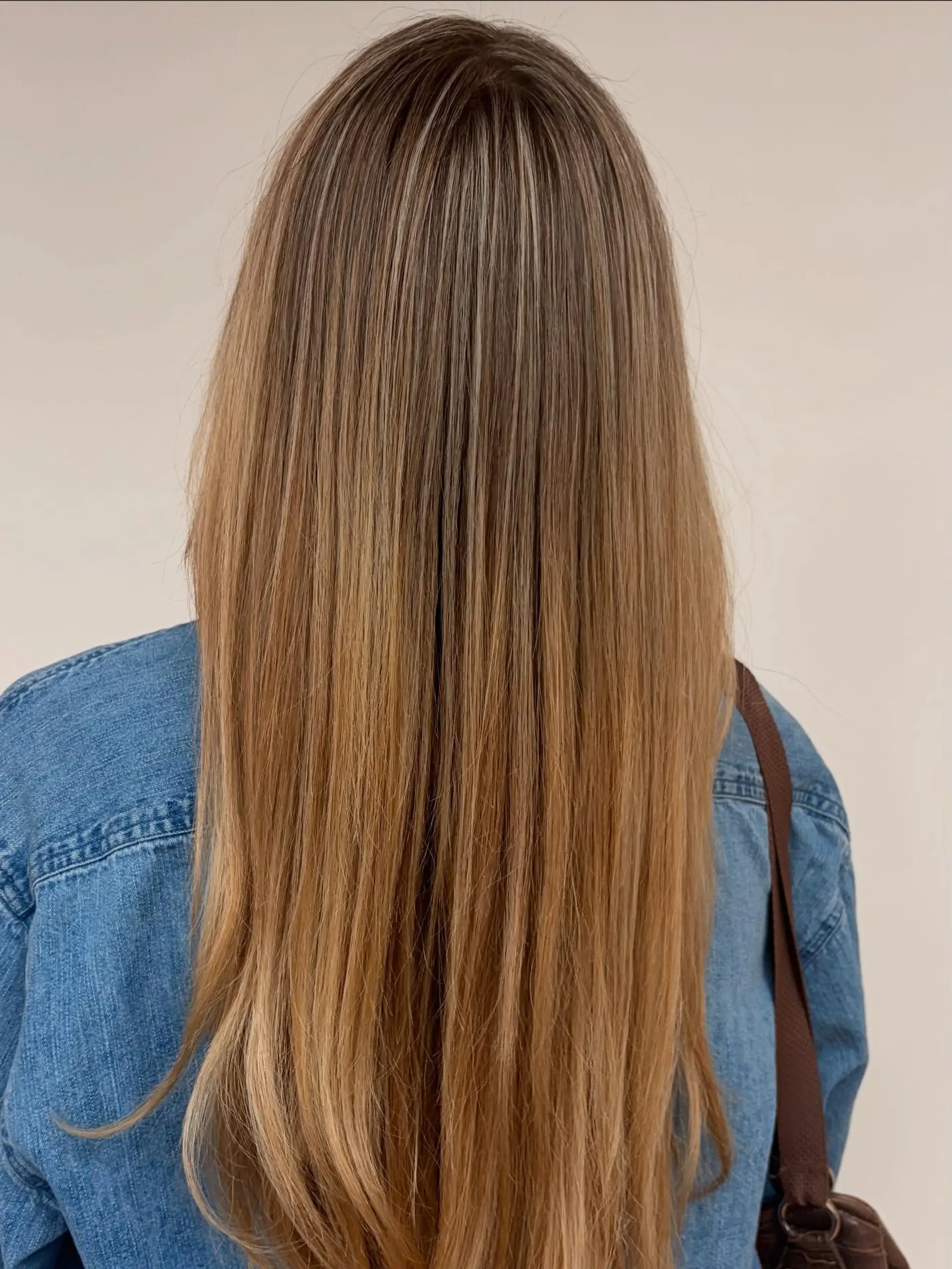 Long, sleek straight hair featuring finely woven 90s-style blonde foil highlights seamlessly blended over a warm golden-brown base. 1