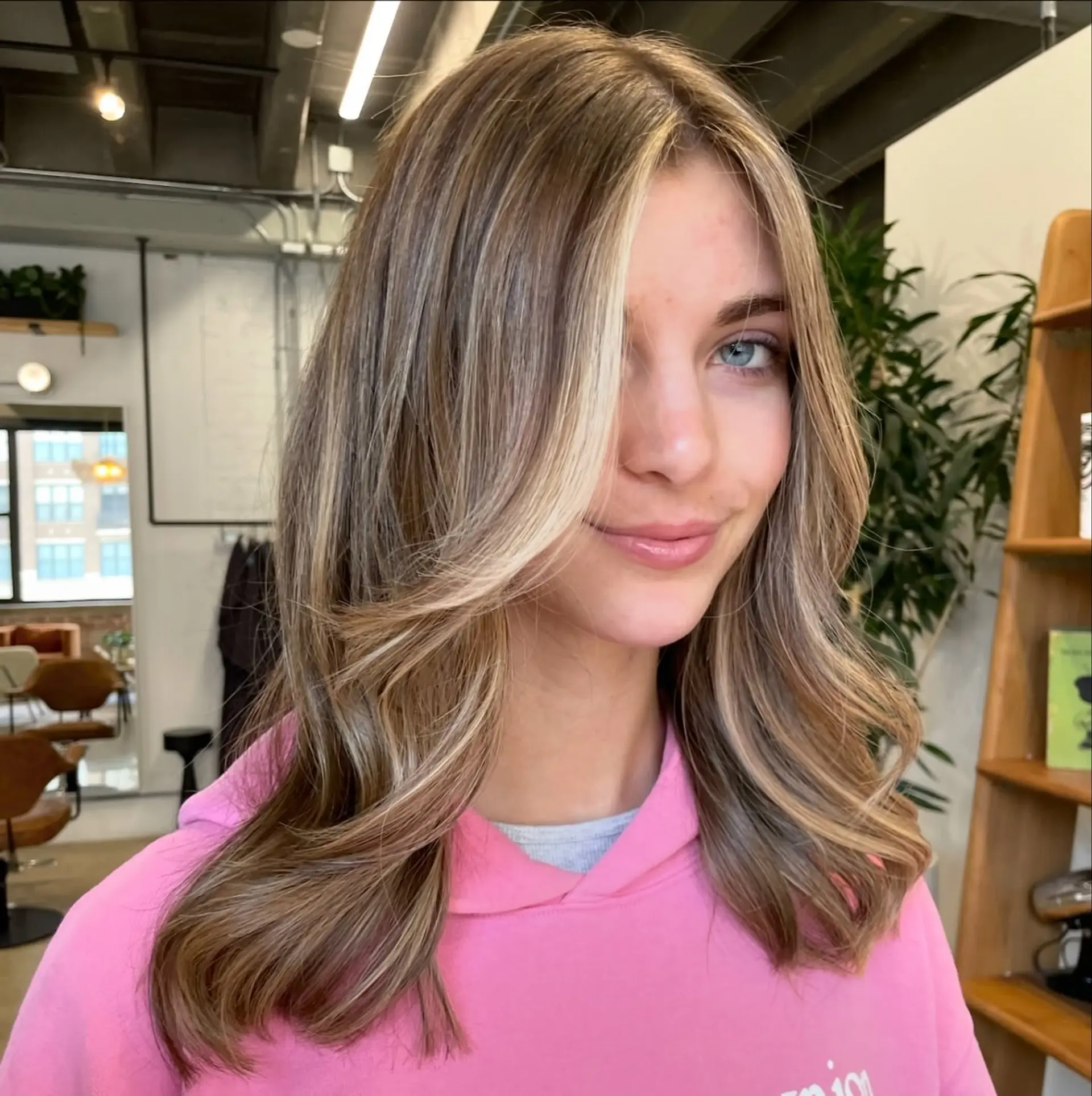 A trendy medium-length hairstyle featuring curtain bangs and face-framing layers. 1