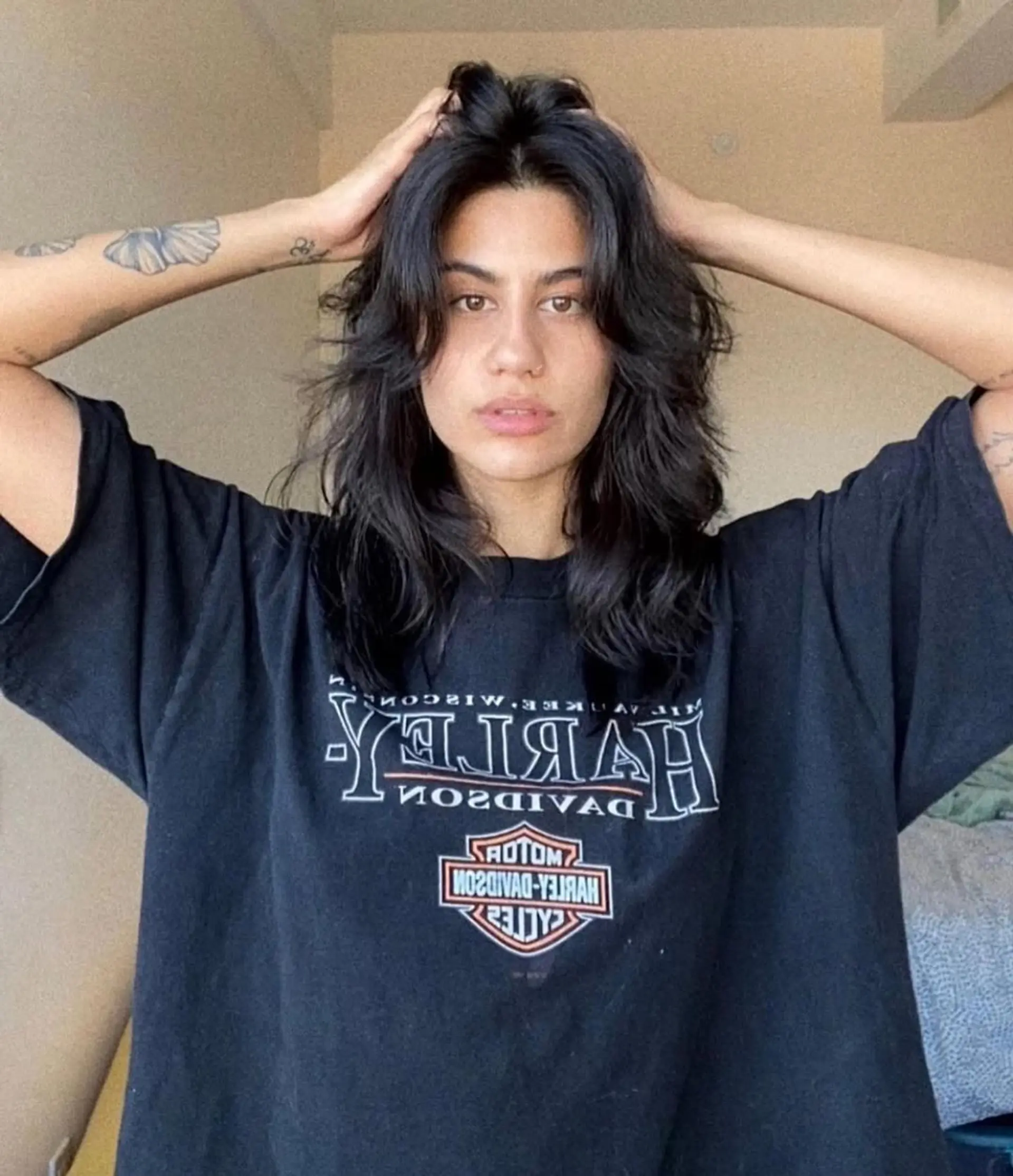 A medium-length wavy hairstyle with shaggy layers and a casual, natural flow. 1