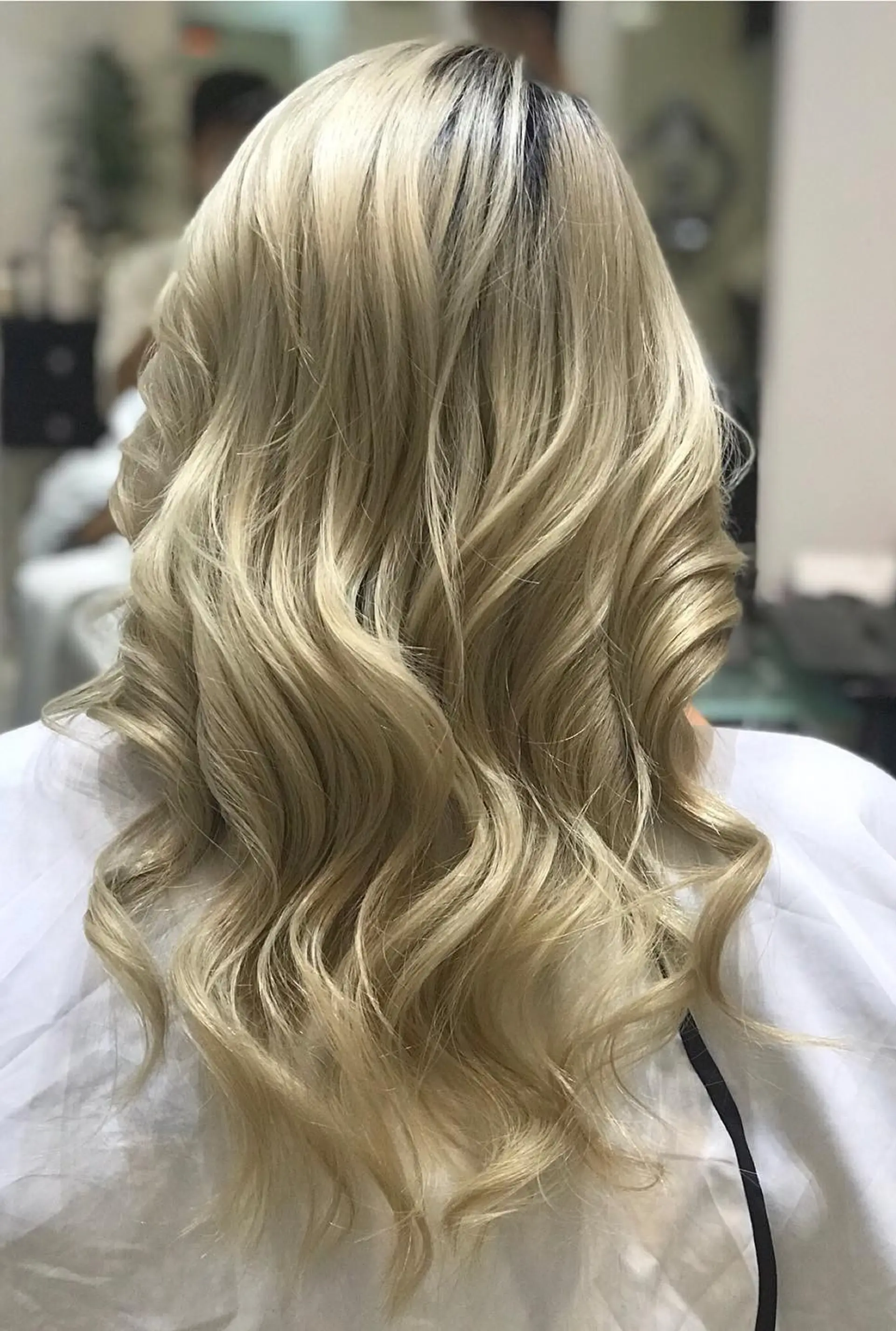 A medium-length wavy style with soft, flowing curls. 1