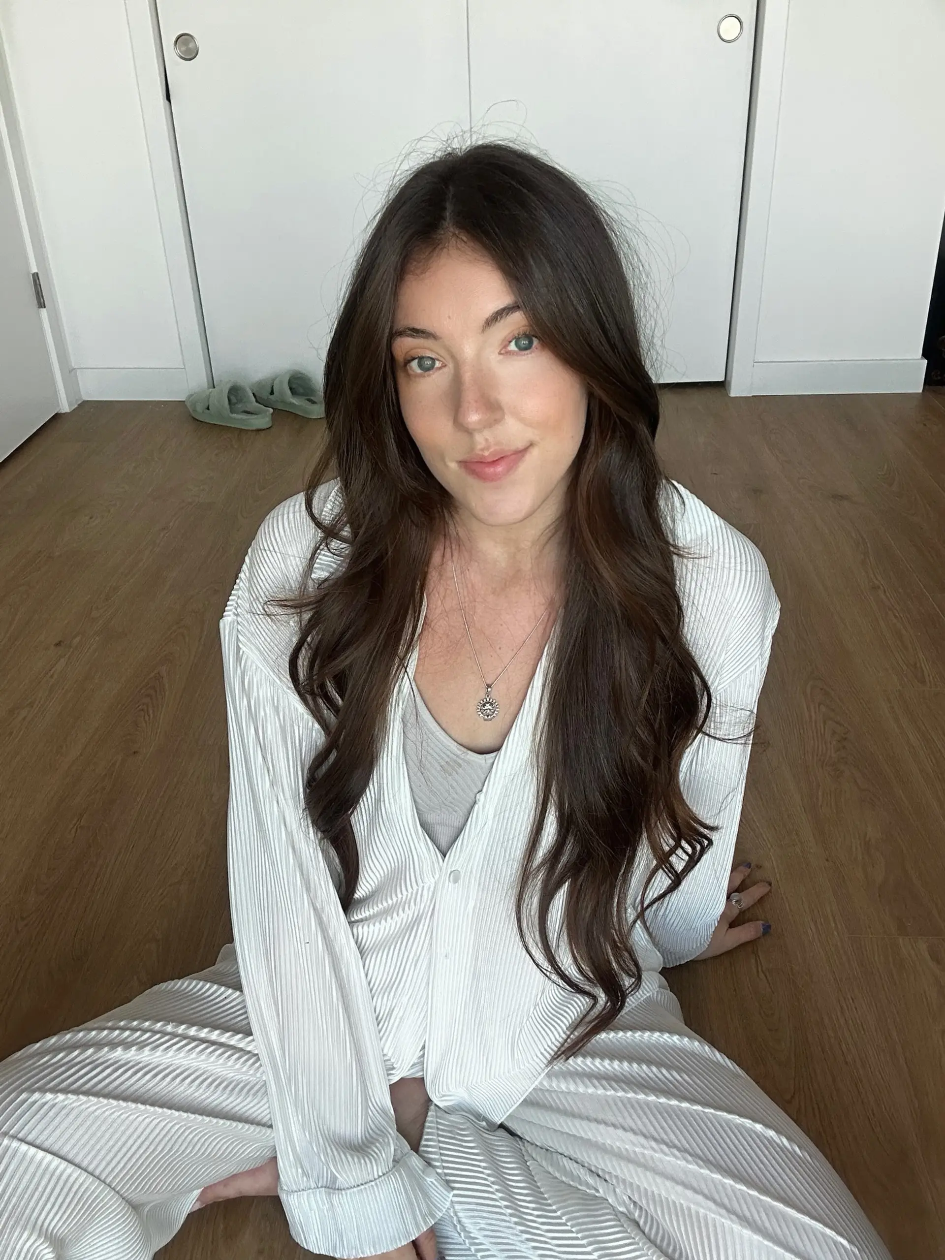 Long dark brown hair styled with soft, loose waves and a middle part. 1