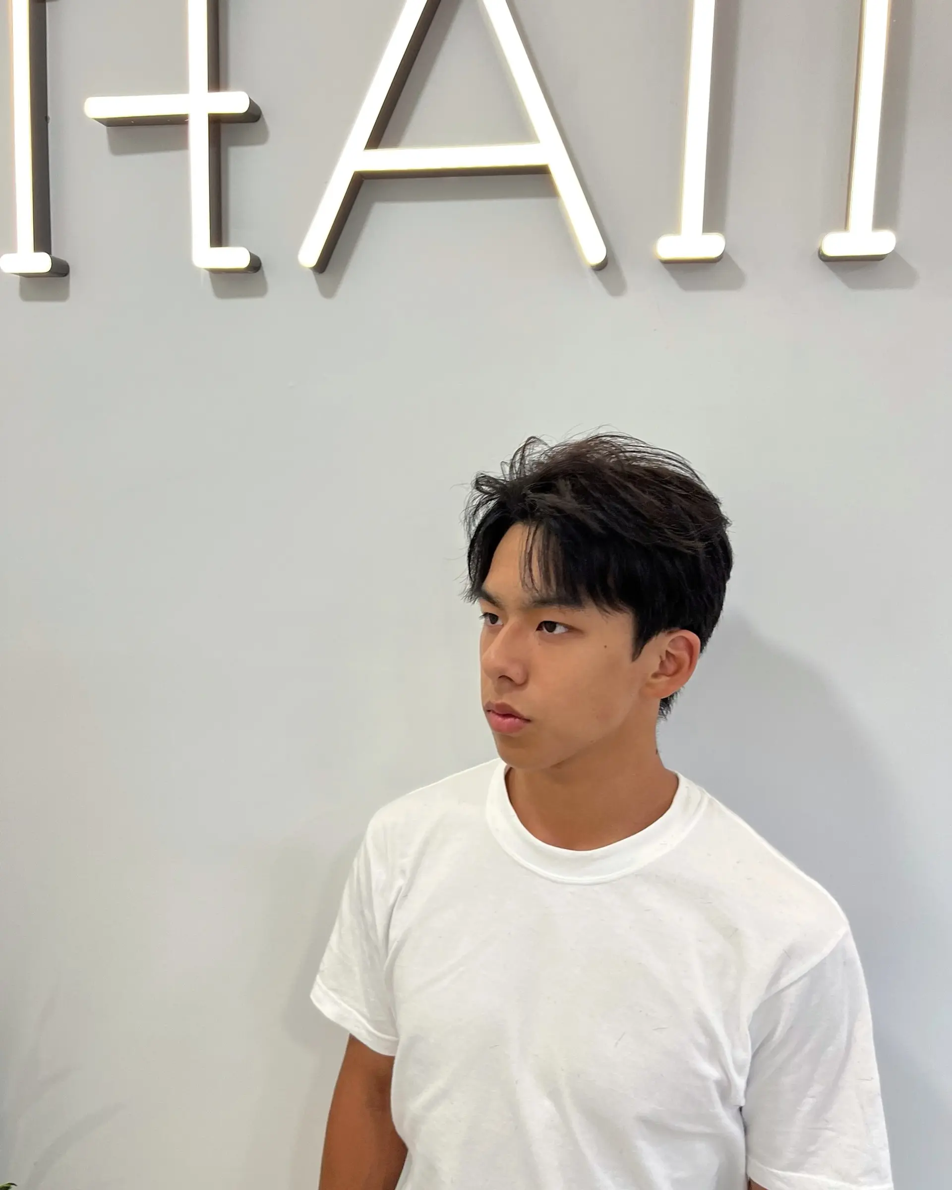 A stylish short textured haircut, featuring a comma-shaped front section. 1