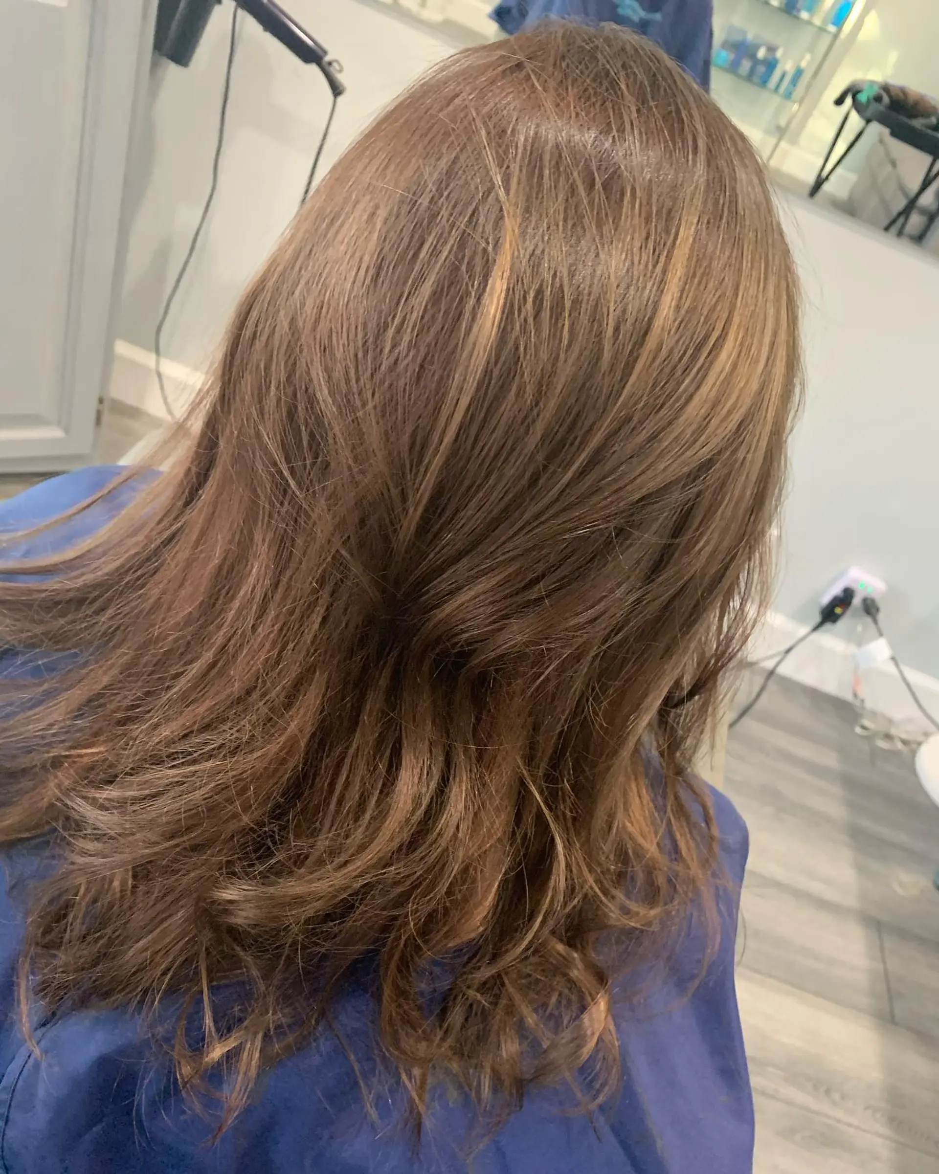Long warm light brown hair with soft natural movement and layered ends. 1