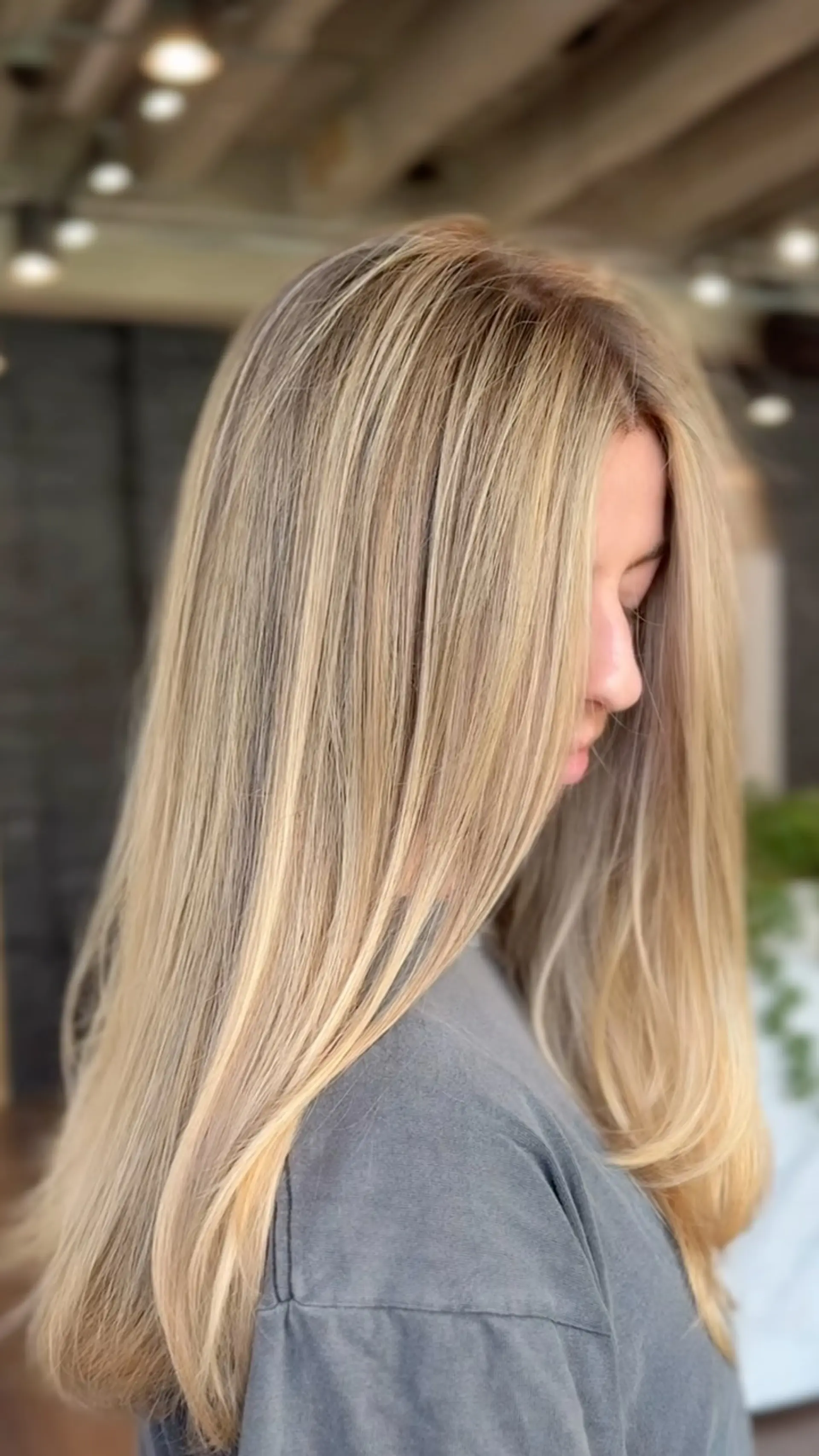 Long, silky dimensional blonde hair styled straight with gentle movement through the ends. 1