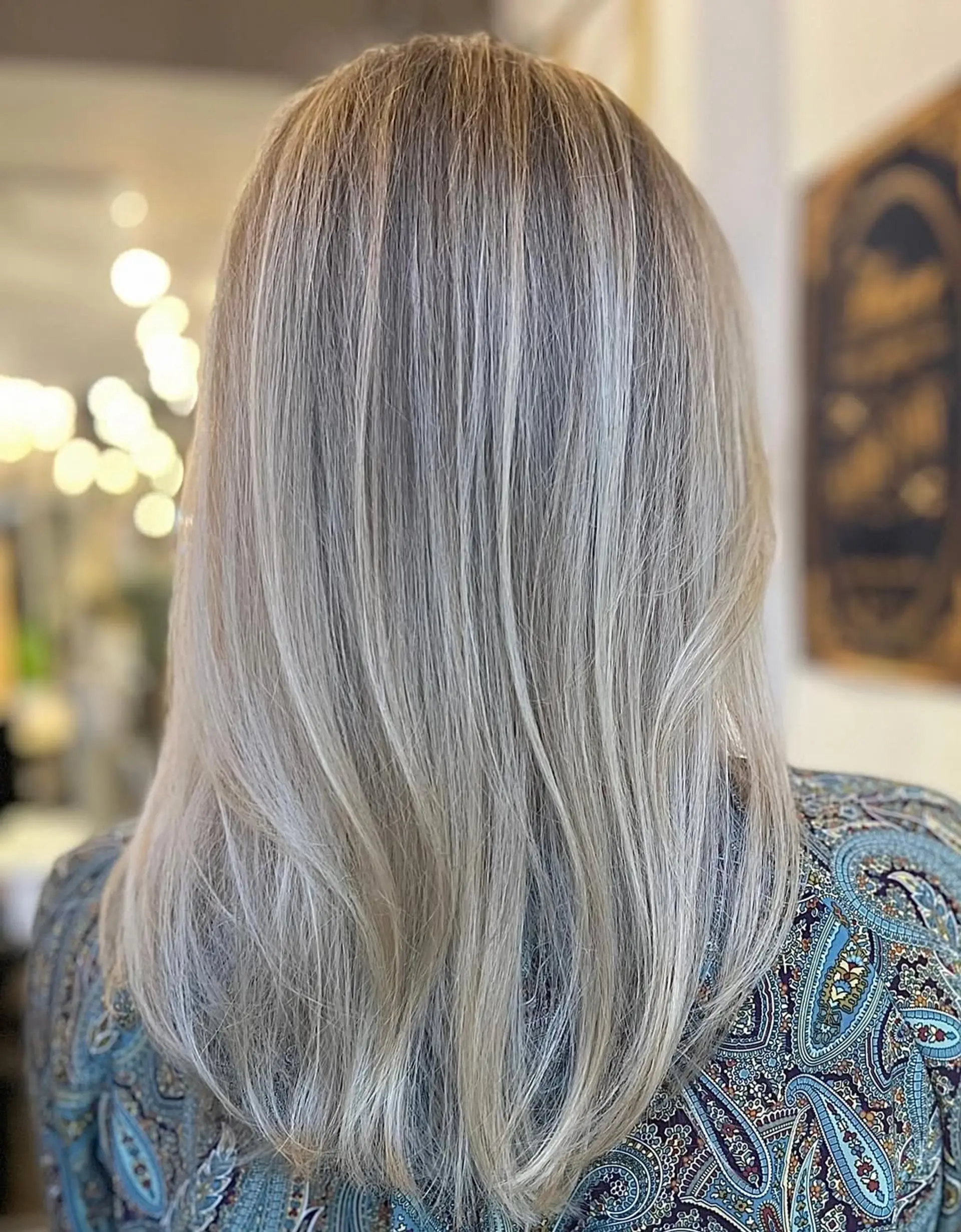 Medium-length straight hair in platinum and ash blonde, featuring soft layers and a smooth finish with natural shine and subtle volume. 1