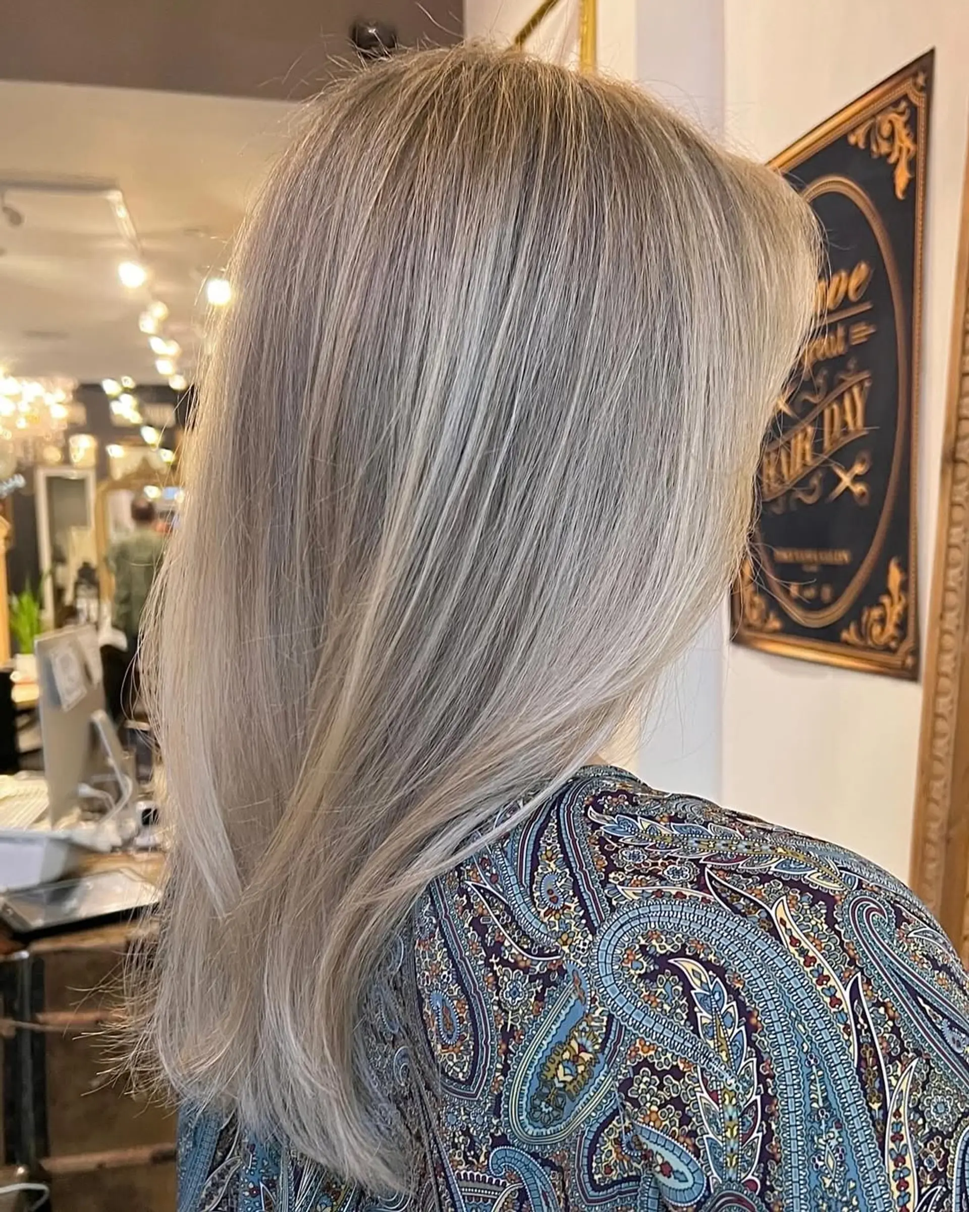Medium-length straight hair in platinum and ash blonde, featuring soft layers and a smooth finish with natural shine and subtle volume. 3