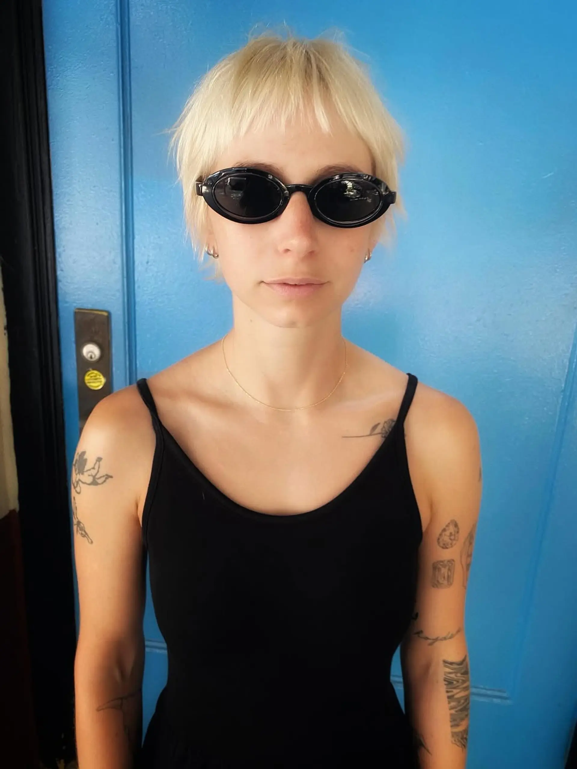 A textured short shag pixie cut with piecey layers and short wispy bangs, perfect for a modern, edgy look. 1