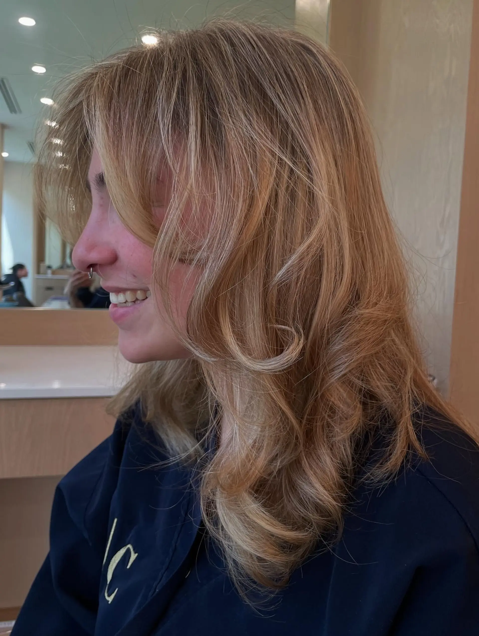 A medium-length shag haircut with curtain bangs and textured layers. 1