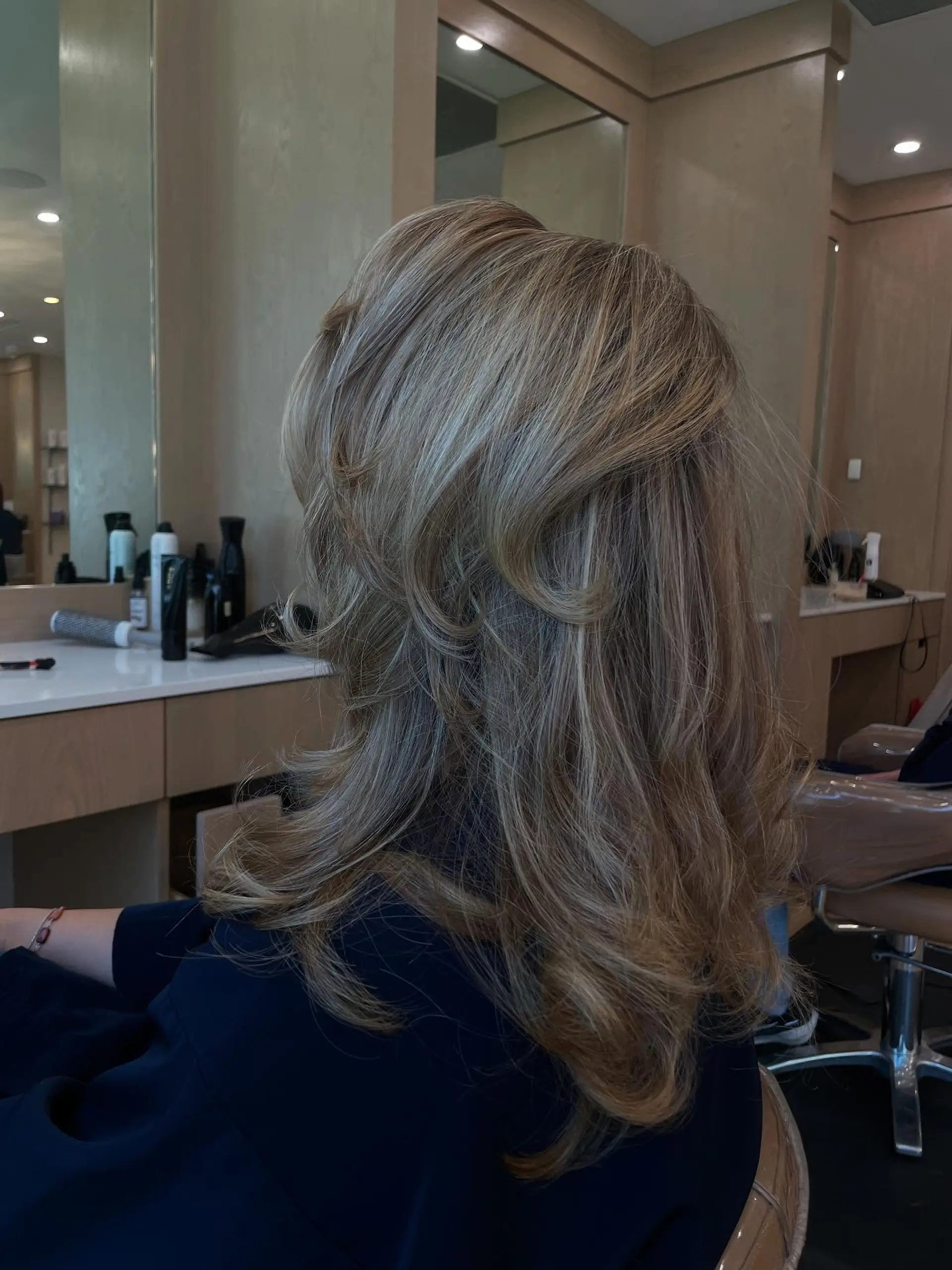 A medium-length shag haircut with curtain bangs and textured layers. 2