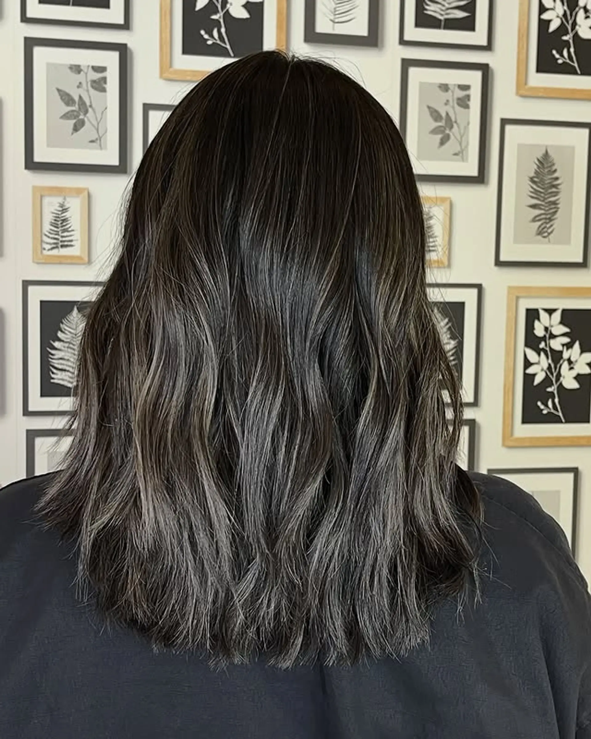 A wavy lob with a black base color and silver-gray balayage highlights. 1