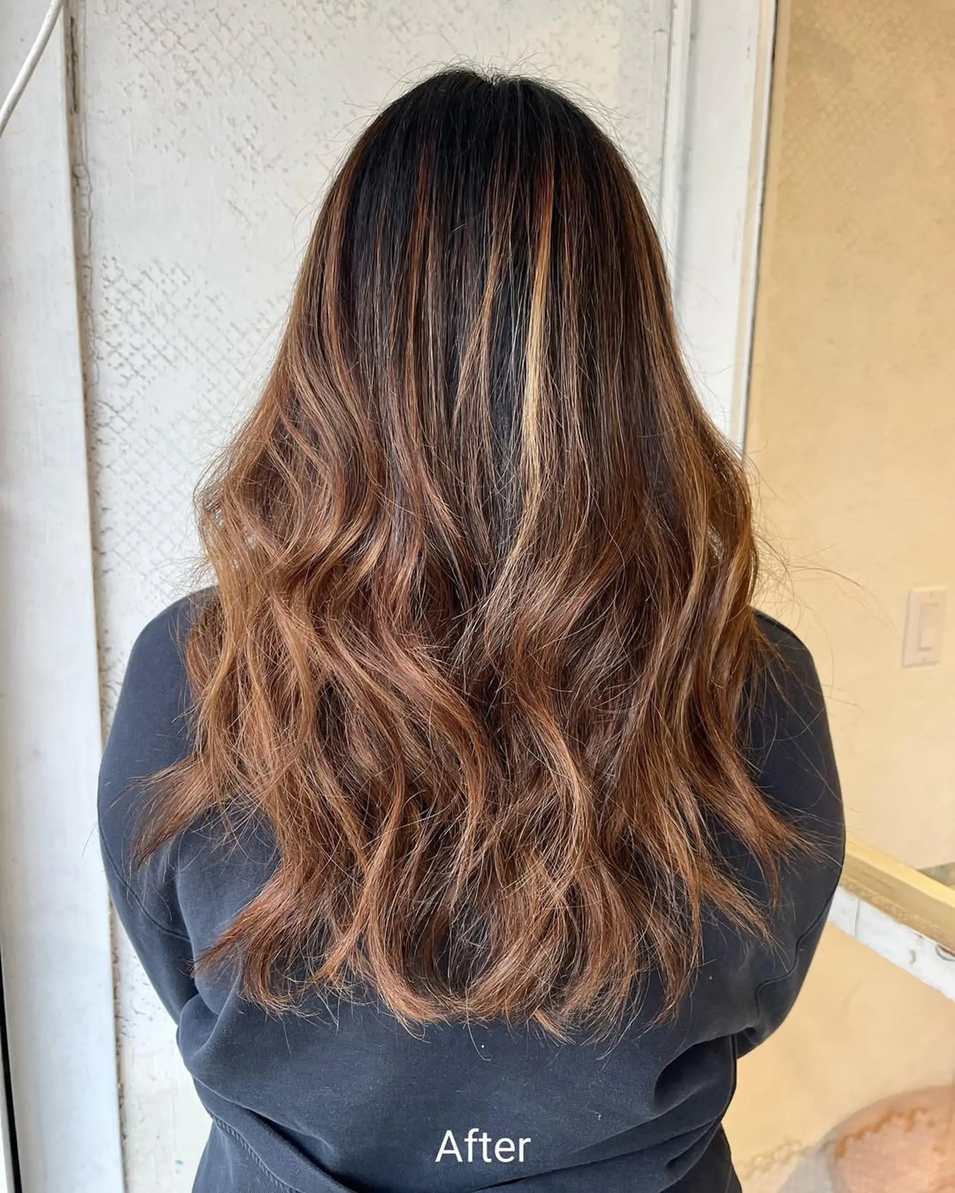Long, wavy hair with dark brown to honey blonde and caramel highlights, featuring soft waves and textured layers for natural flow and warmth. 1