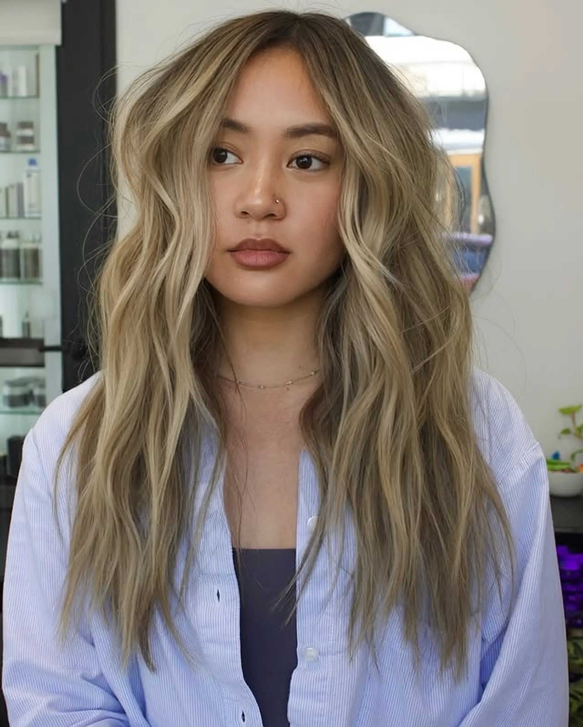 Long, wavy hair with an ash blonde balayage. 1