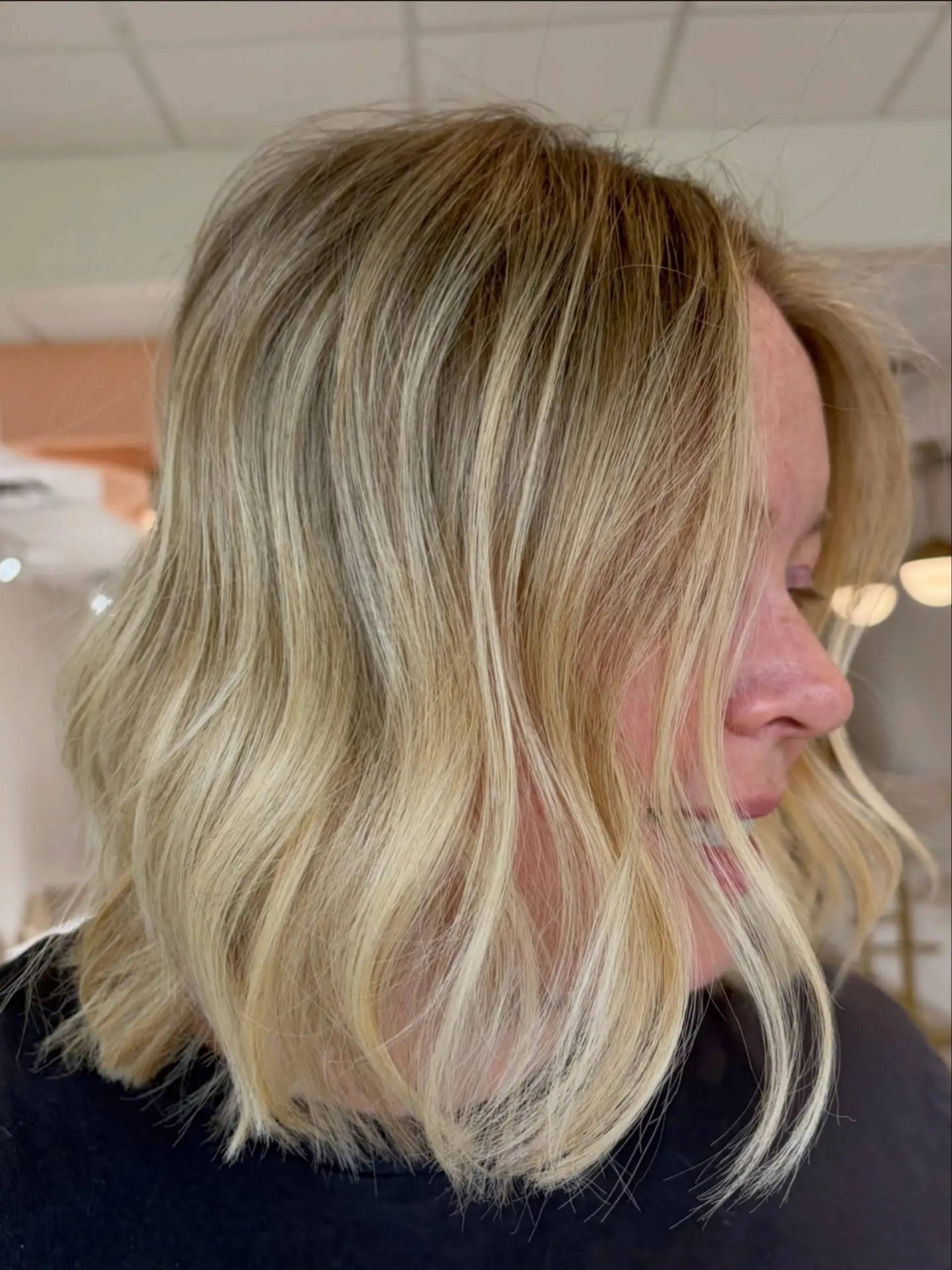 A dimensional bright blonde lob styled with soft, textured waves. 1