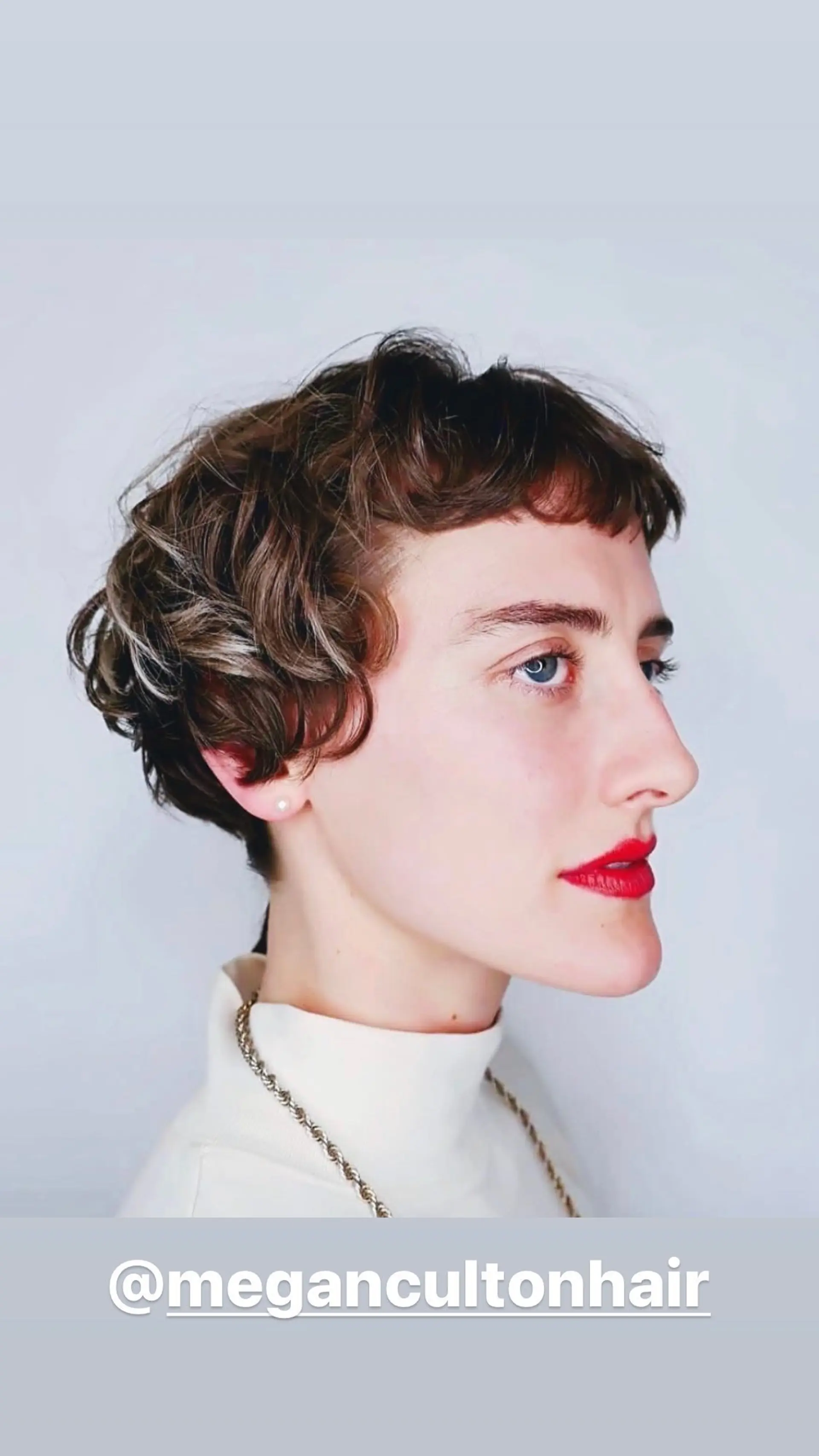 A short, wavy pixie cut with baby bangs and blonde highlights. 1