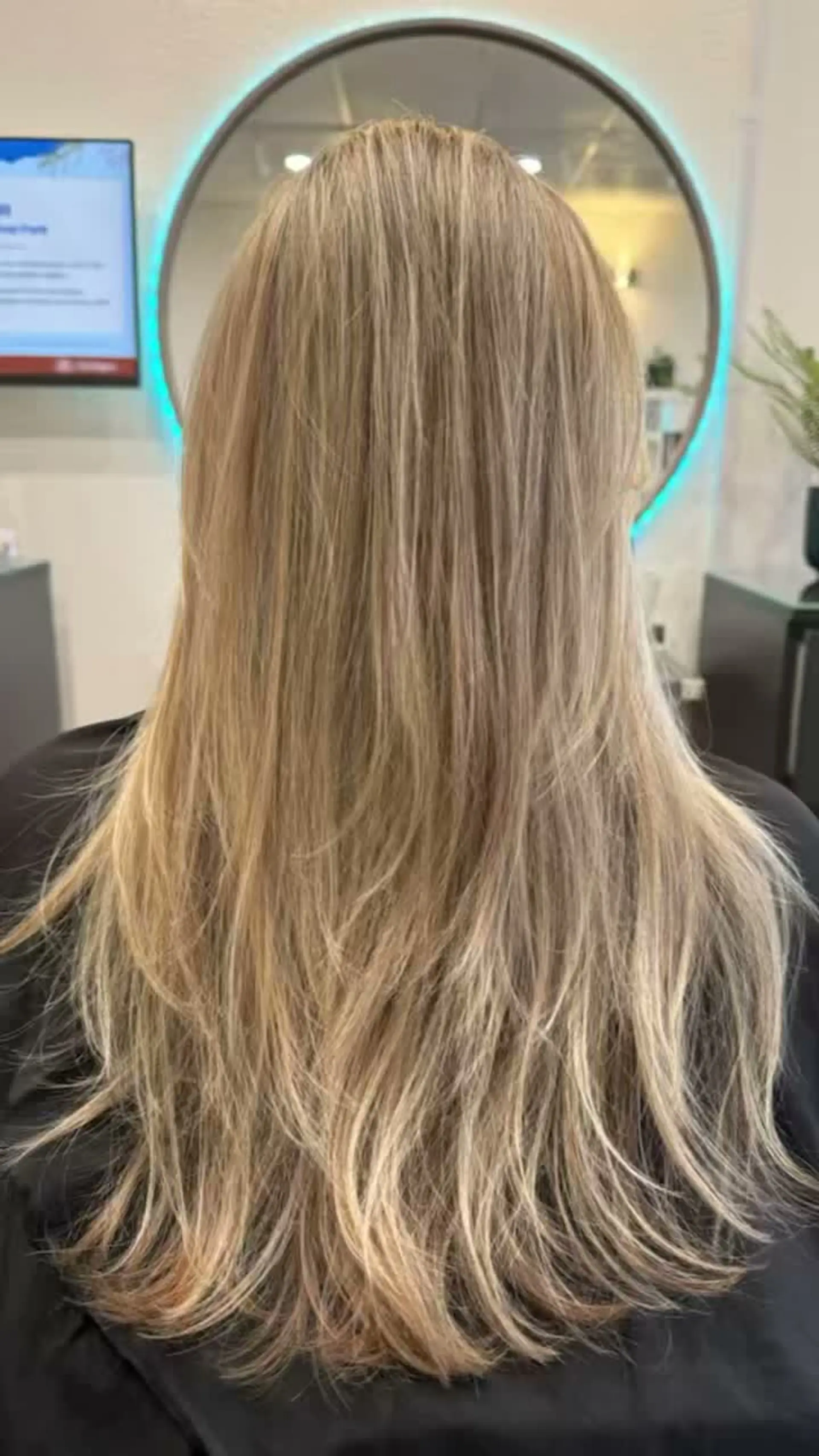 Smooth, long blonde hair styled straight with soft, textured layers throughout the ends. 1