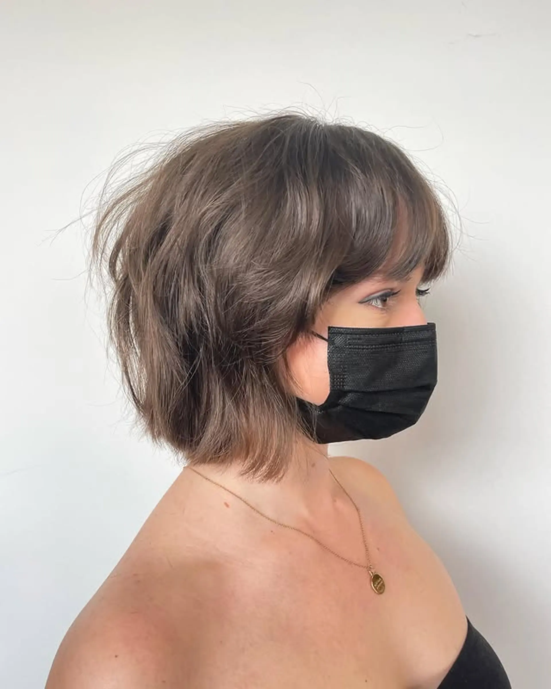 A modern, shaggy bob with choppy layers and textured bangs. 1