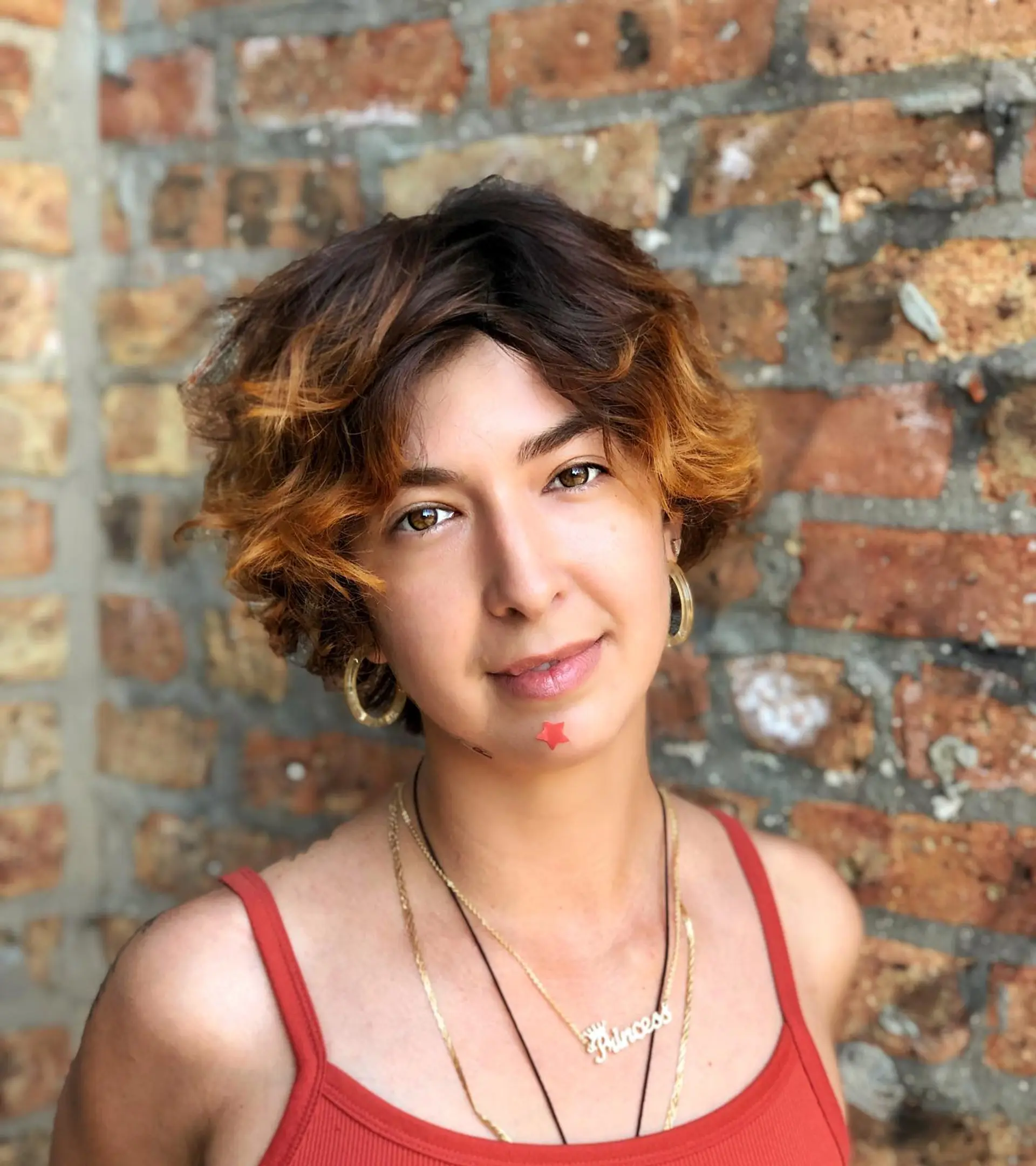 A short, textured bob with a root shadow effect, transitioning to a bronzed blonde balayage. 1