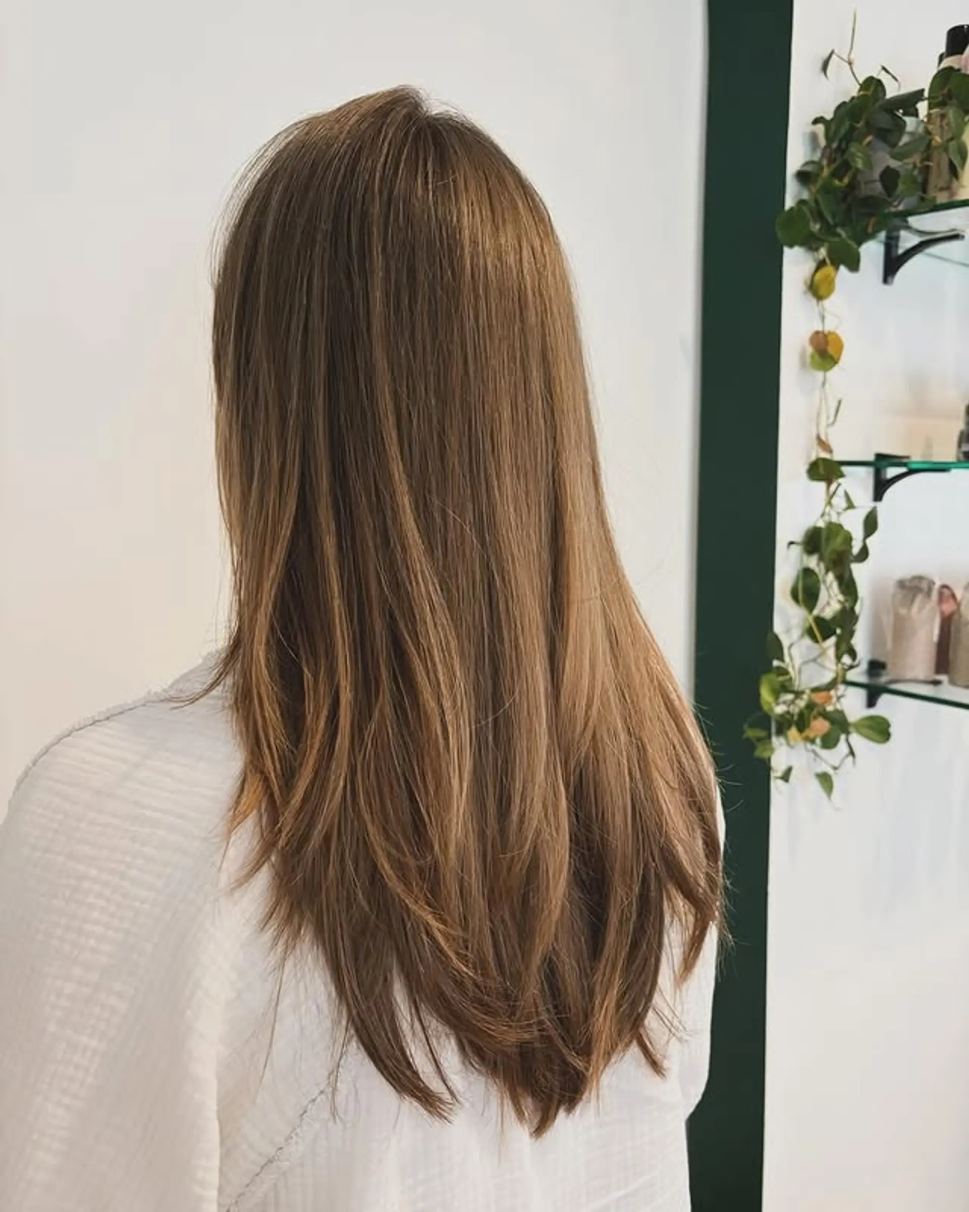 Long layered hairstyle with a seamless balayage color melt. 1