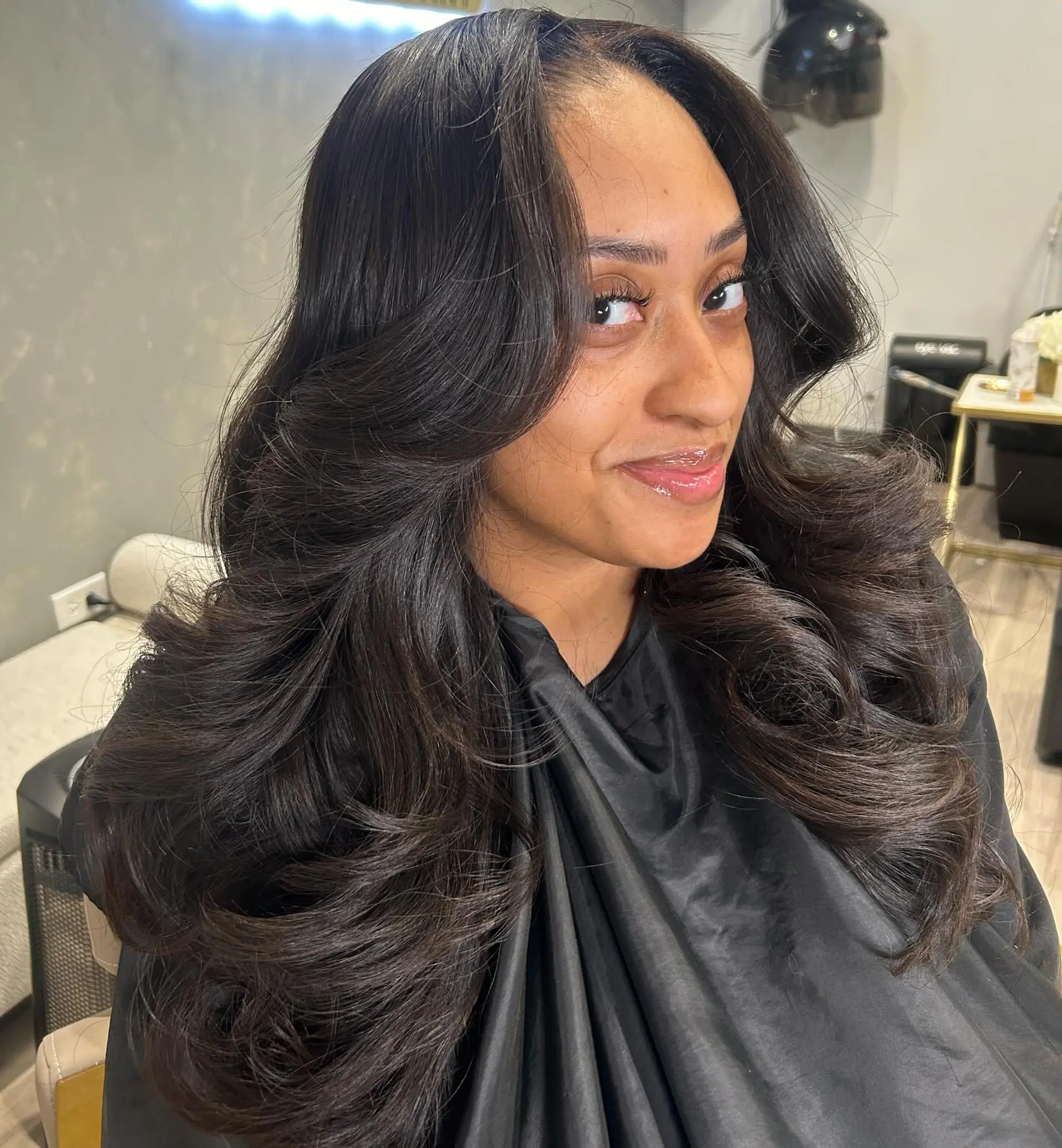 A beautiful layered haircut with long wavy hair, styled for maximum volume and glamour. 1