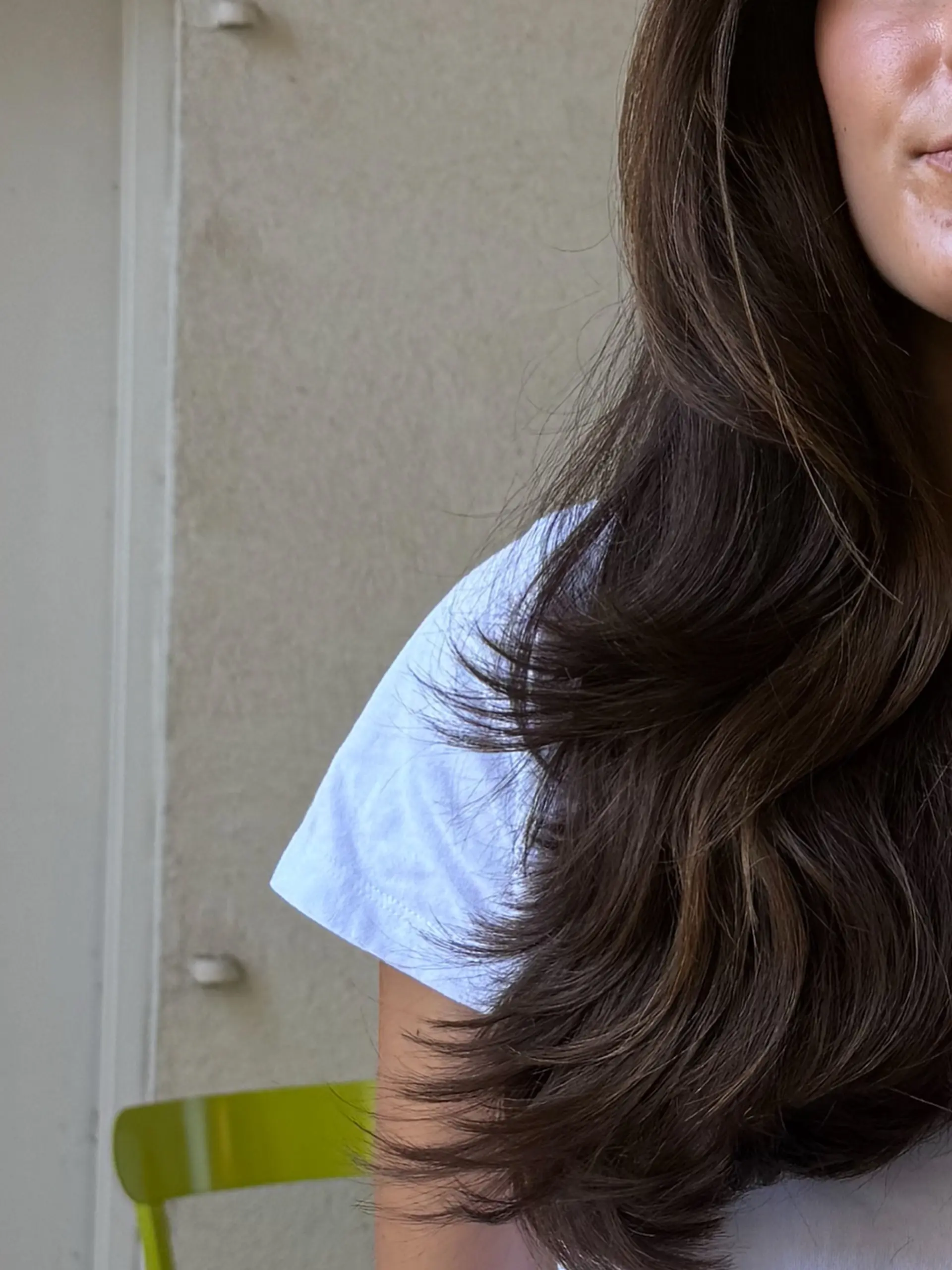 Long dark brown hair styled with cascading layers and soft face-framing movement. 1