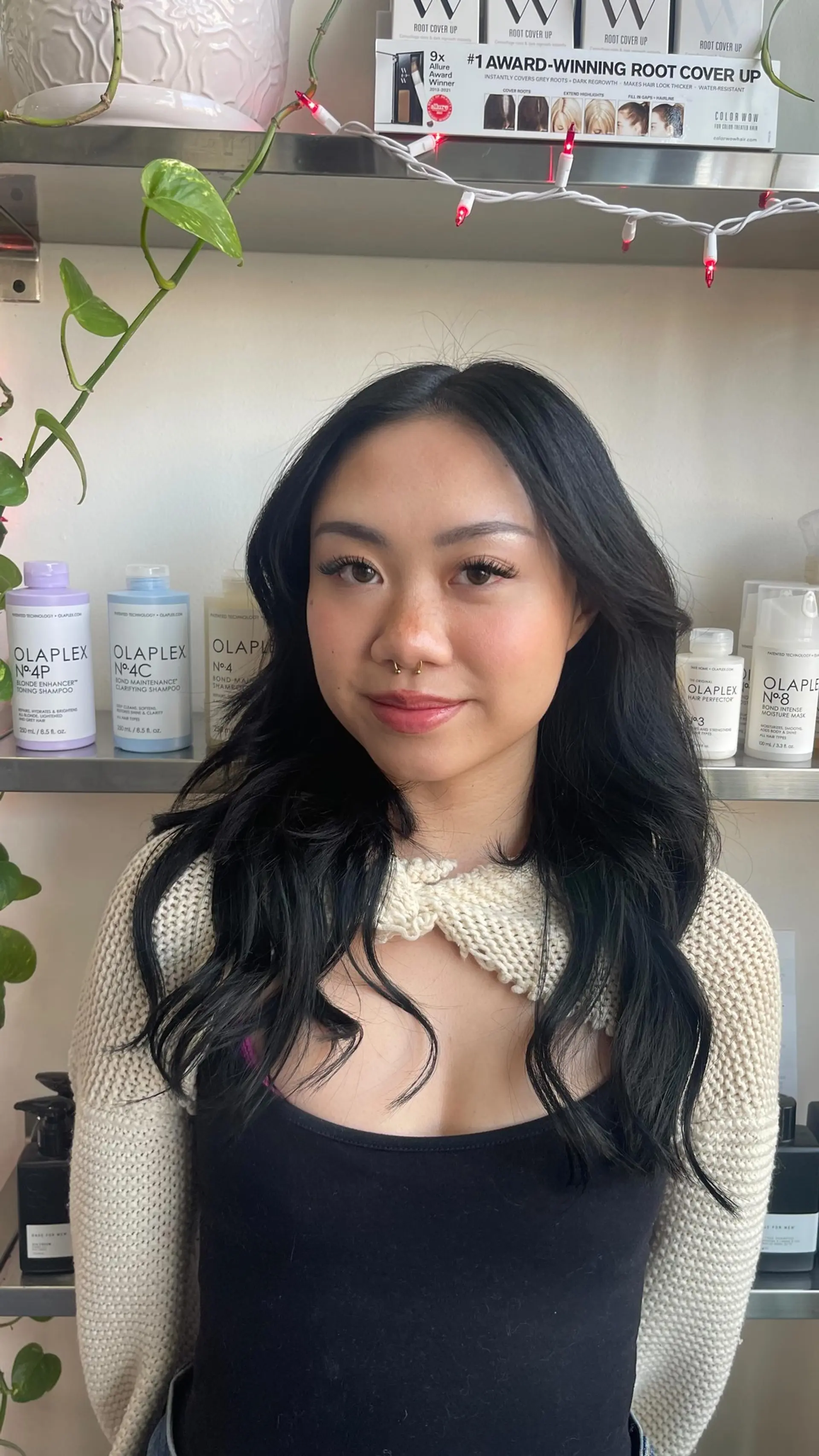 Long jet black hair styled with soft, cascading waves and a classic middle part. 1