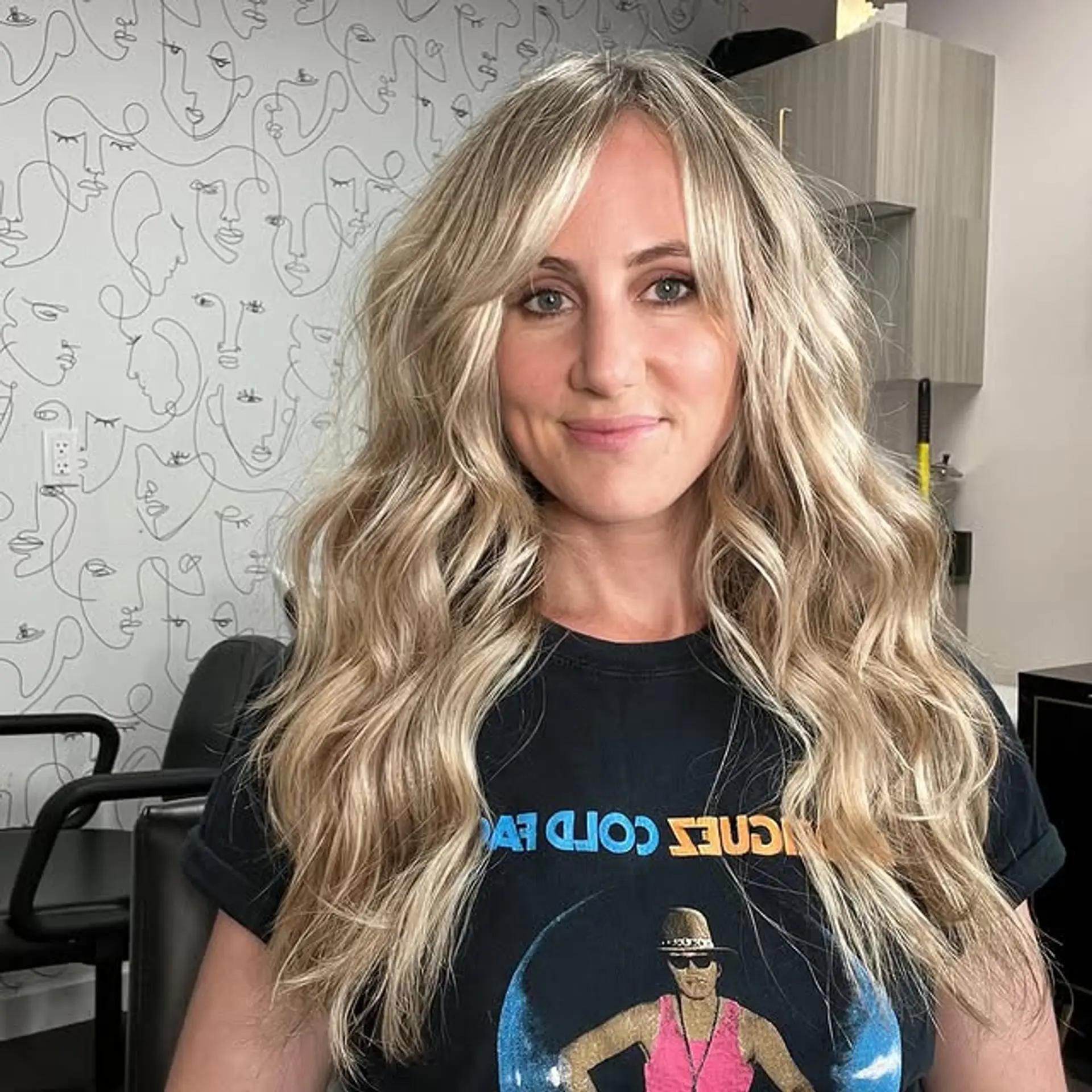 Long, wavy blonde hair with curtain bangs and face-framing layers. 1