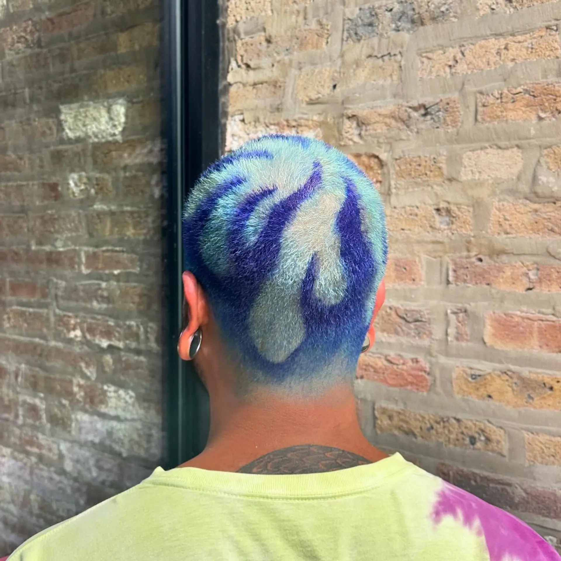 A very short buzzcut with a unique floral design. 2