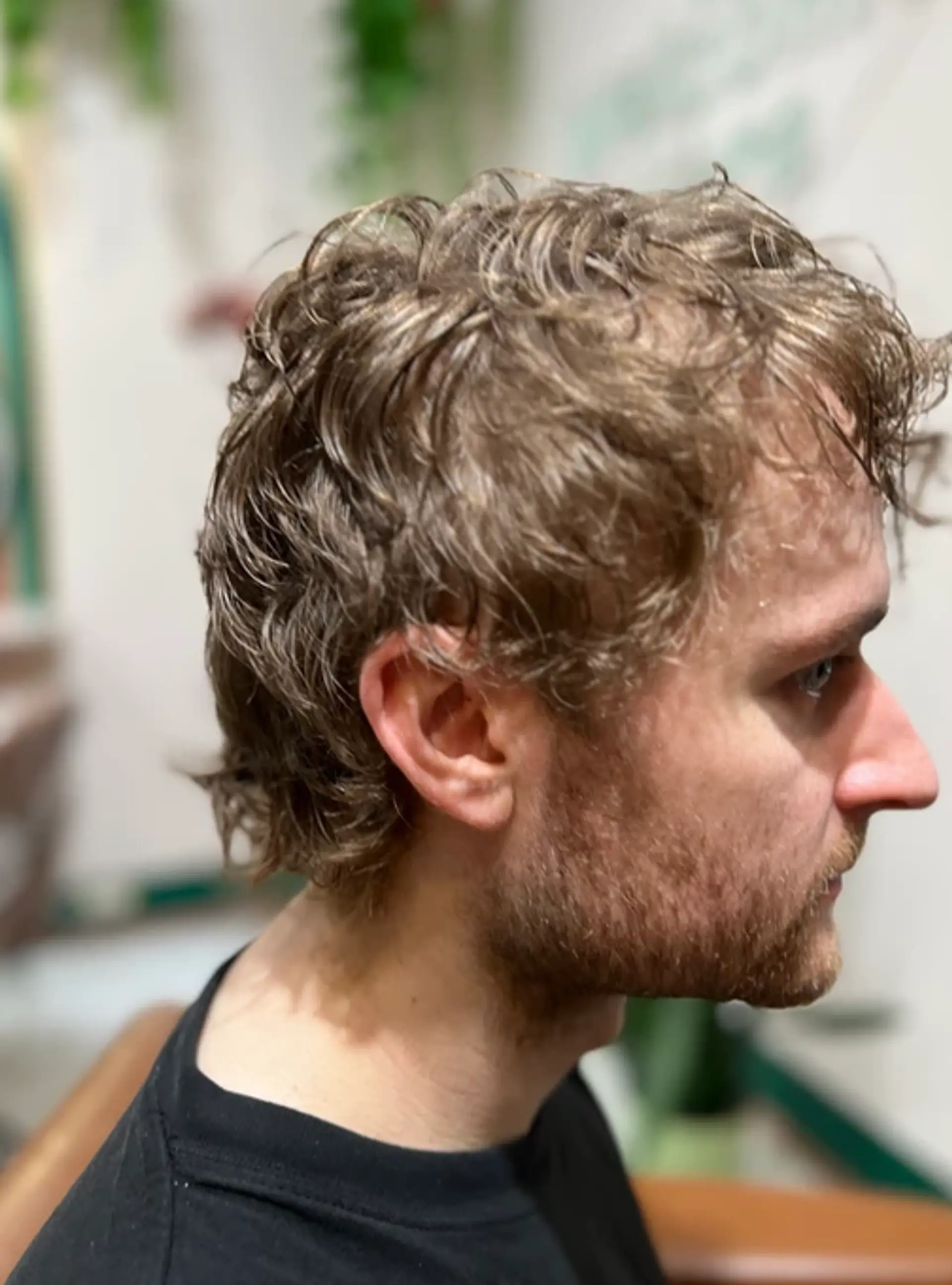 A short, tousled hairstyle with natural waves and textured layers, revealing the ears and creating a casual, effortless look. 1