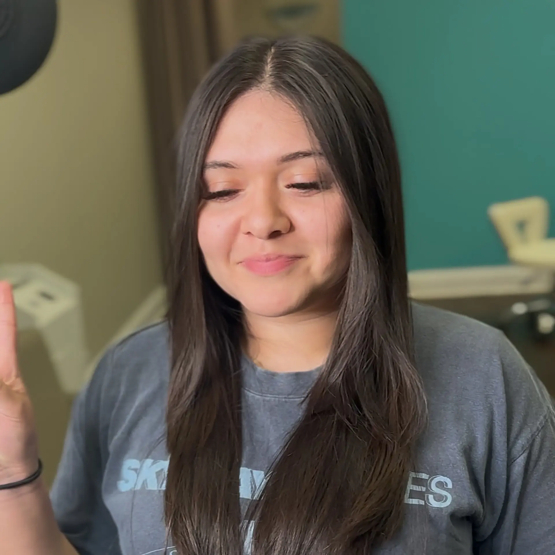 Long, smooth dark brown hair parted down the center with a glossy, frizz-free straight finish. 1