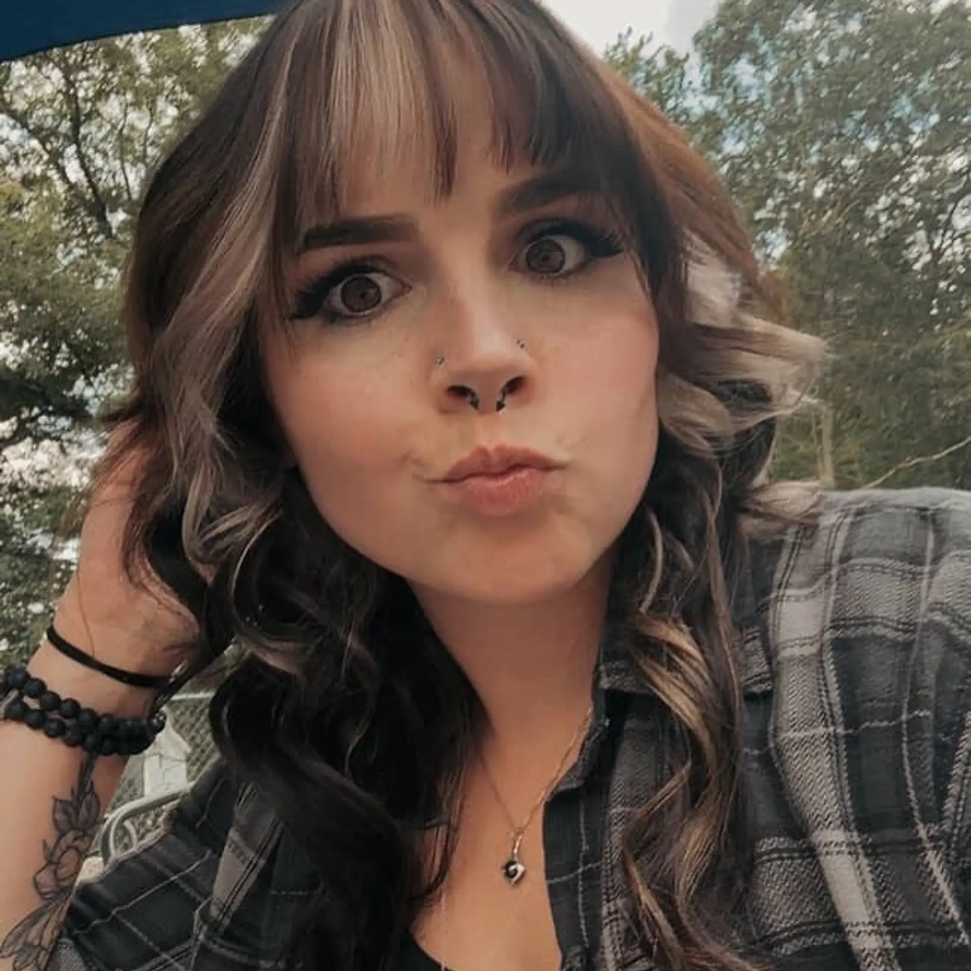 Medium-length wavy wolf cut featuring textured fringe bangs and blonde color blocking framing the face. 1