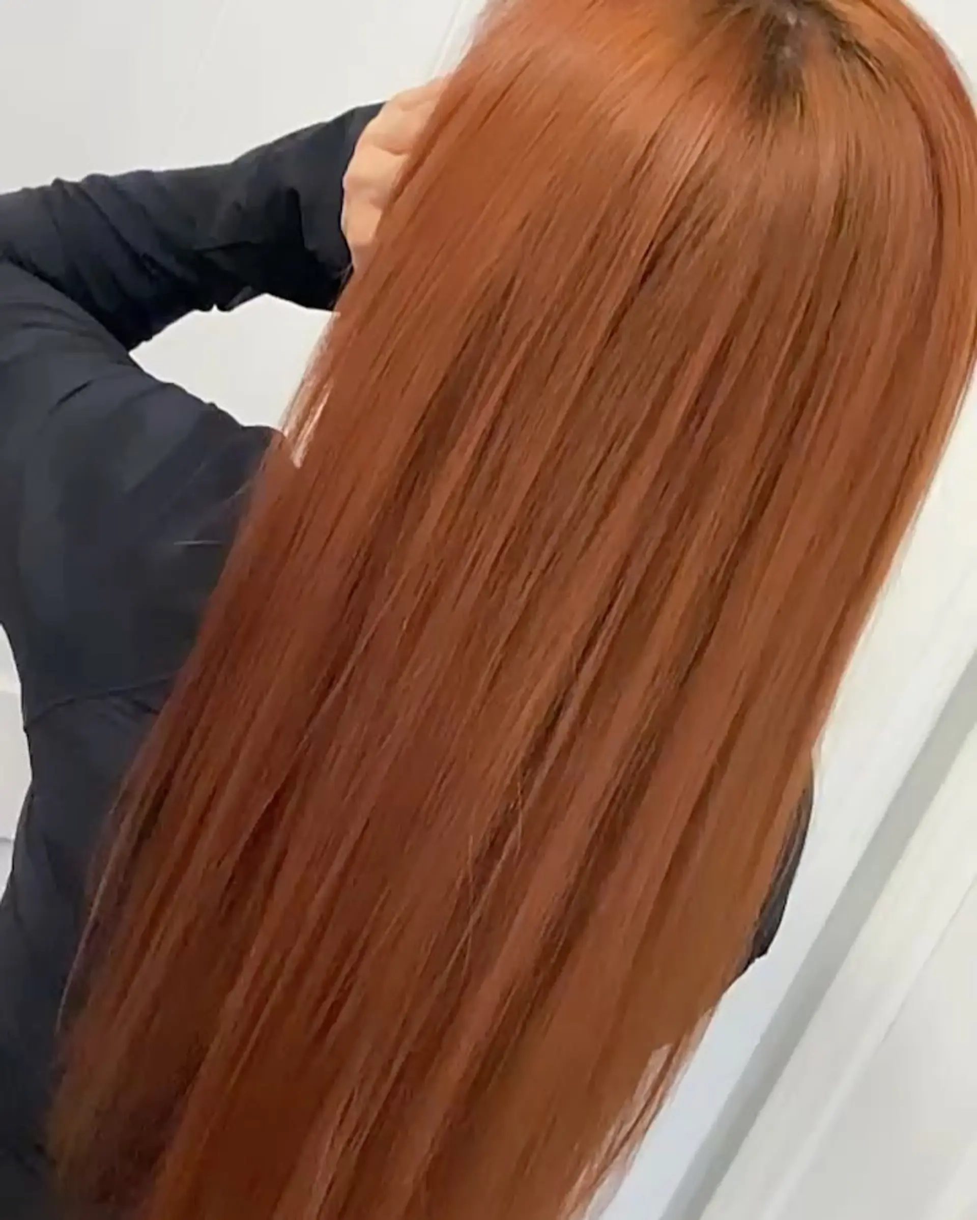 Long, silky smooth copper hair styled ultra-straight with high shine. 1