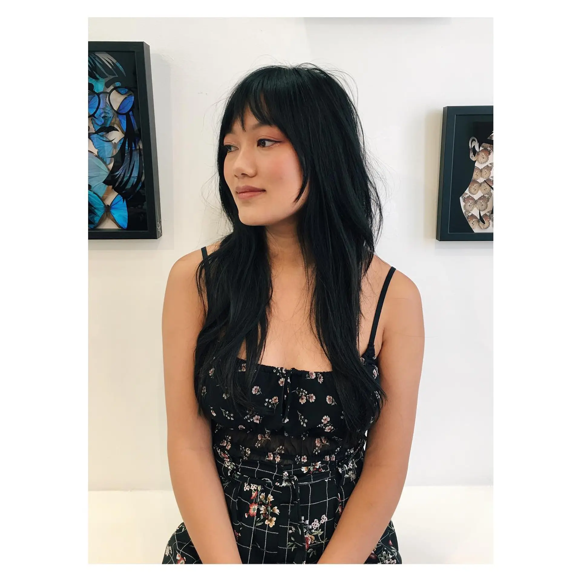 Long black hair featuring a textured razor cut with wispy bangs and face-framing layers. 1